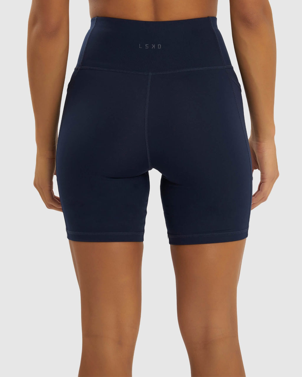 Model wearing Rep Mid Short Tight Small Logo - Navy