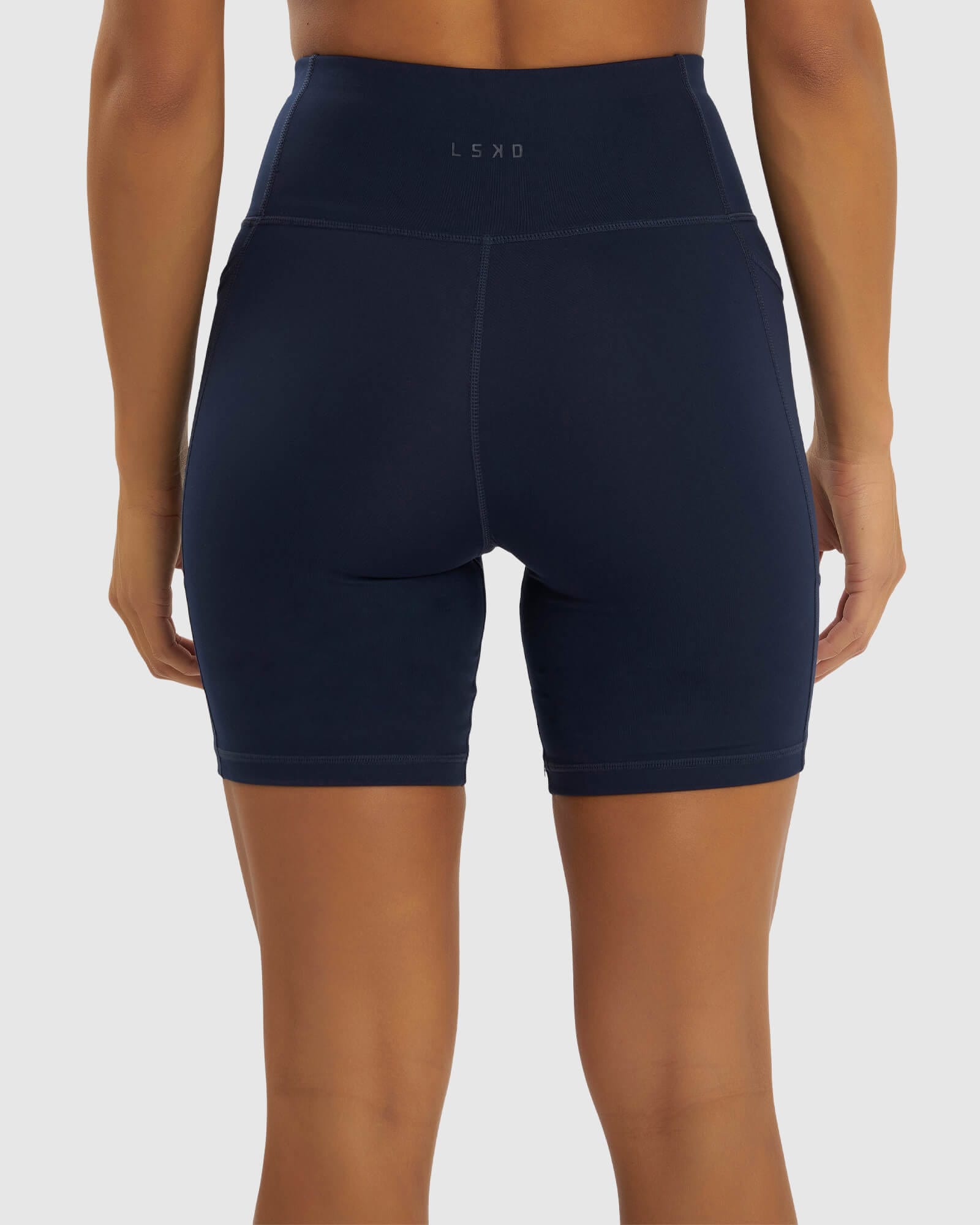 Model wearing Rep Mid Short Tight Small Logo - Navy