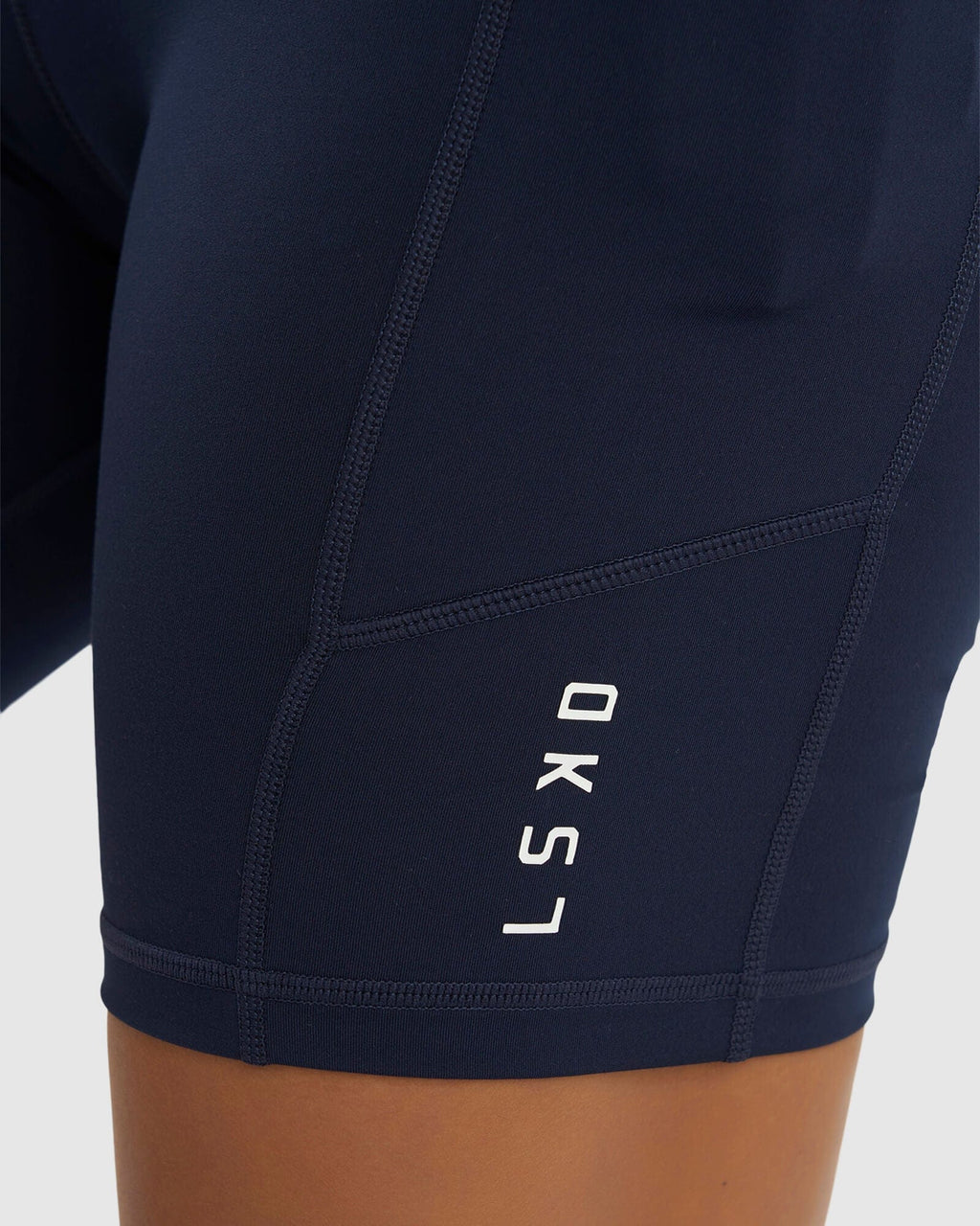 Model wearing Rep Mid Short Tight Small Logo - Navy