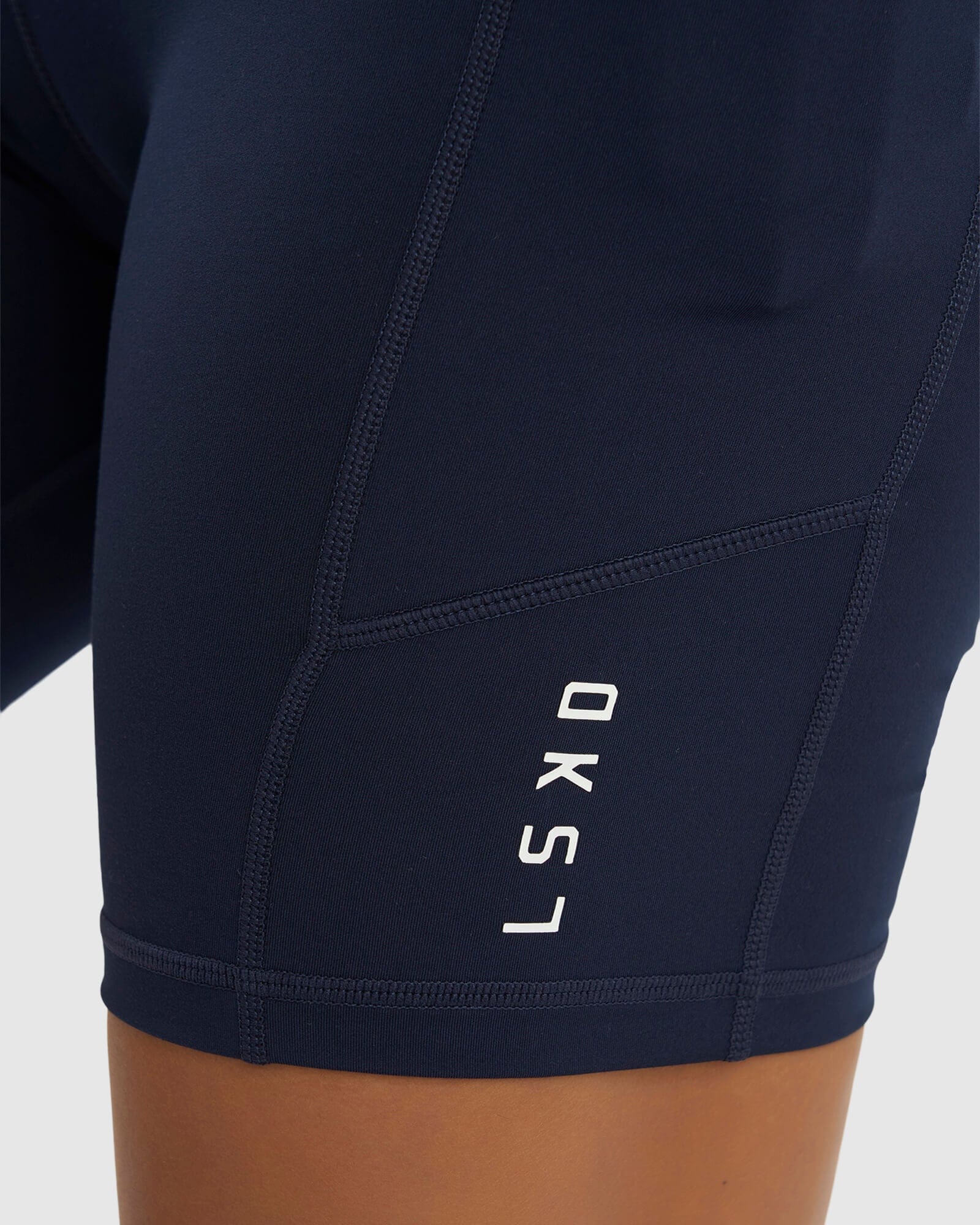 Model wearing Rep Mid Short Tight Small Logo - Navy