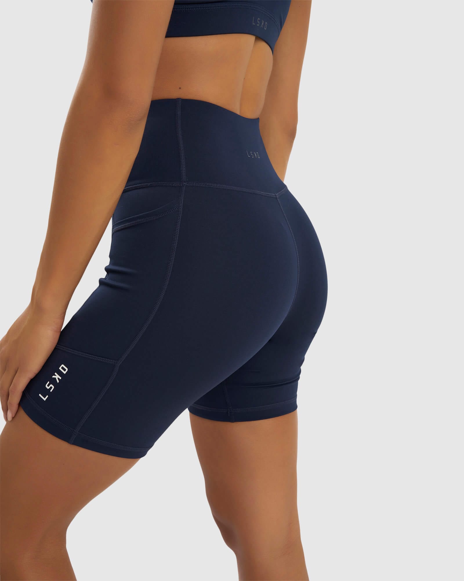 Model wearing Rep Mid Short Tight Small Logo - Navy