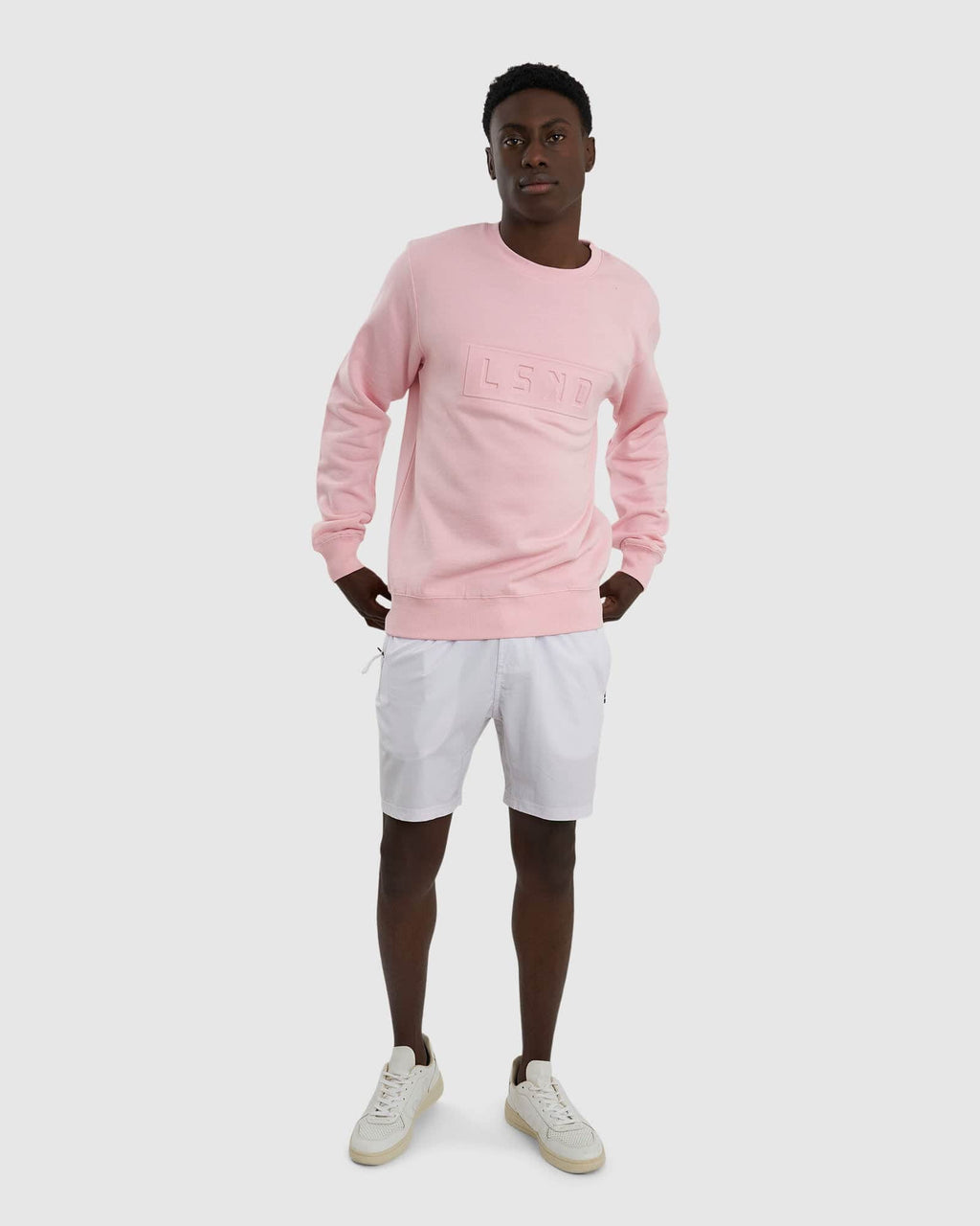 Model wearing Unisex Imprint Sweater - Petal Pink