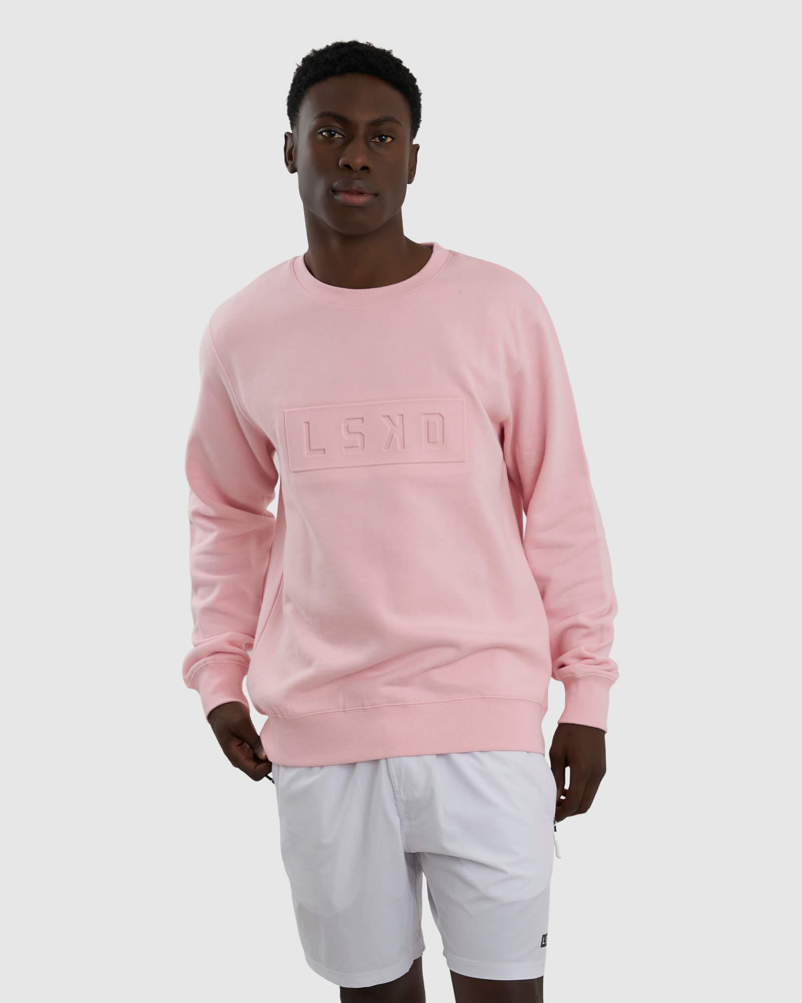 Model wearing Unisex Imprint Sweater - Petal Pink