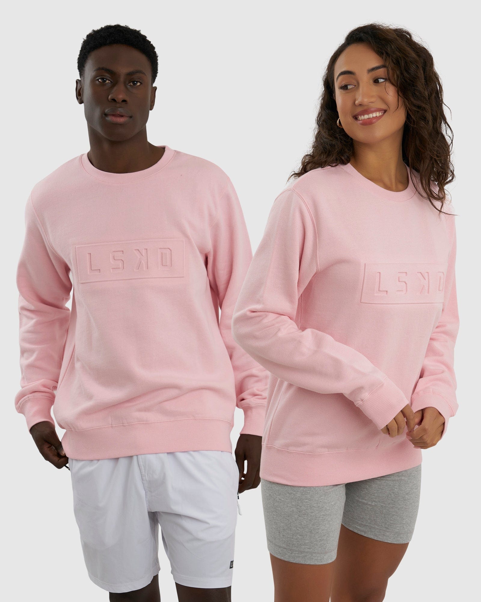 Model wearing Unisex Imprint Sweater - Petal Pink