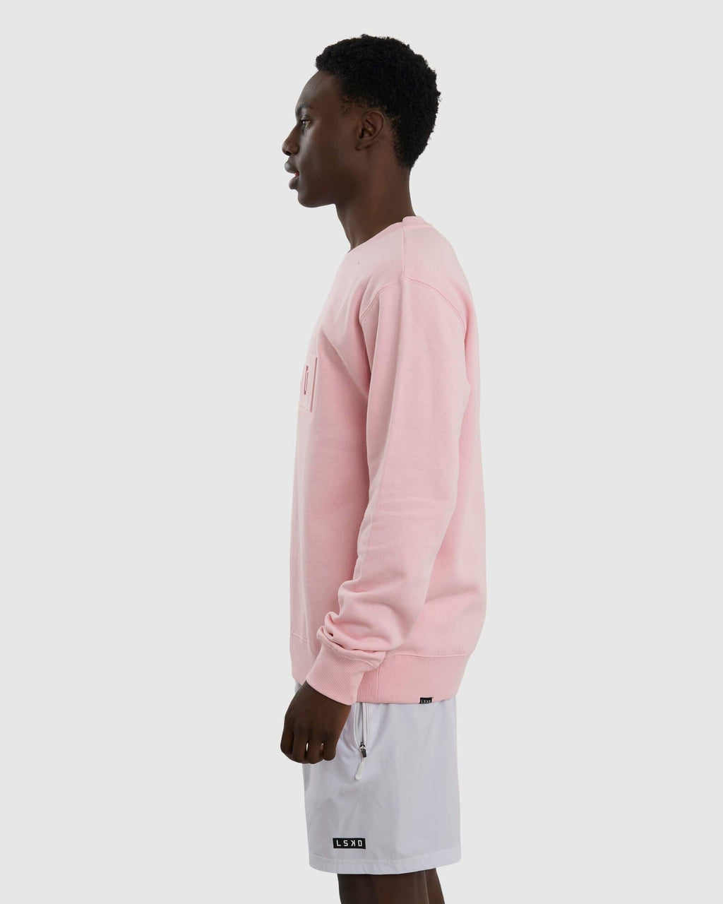 Model wearing Unisex Imprint Sweater - Petal Pink