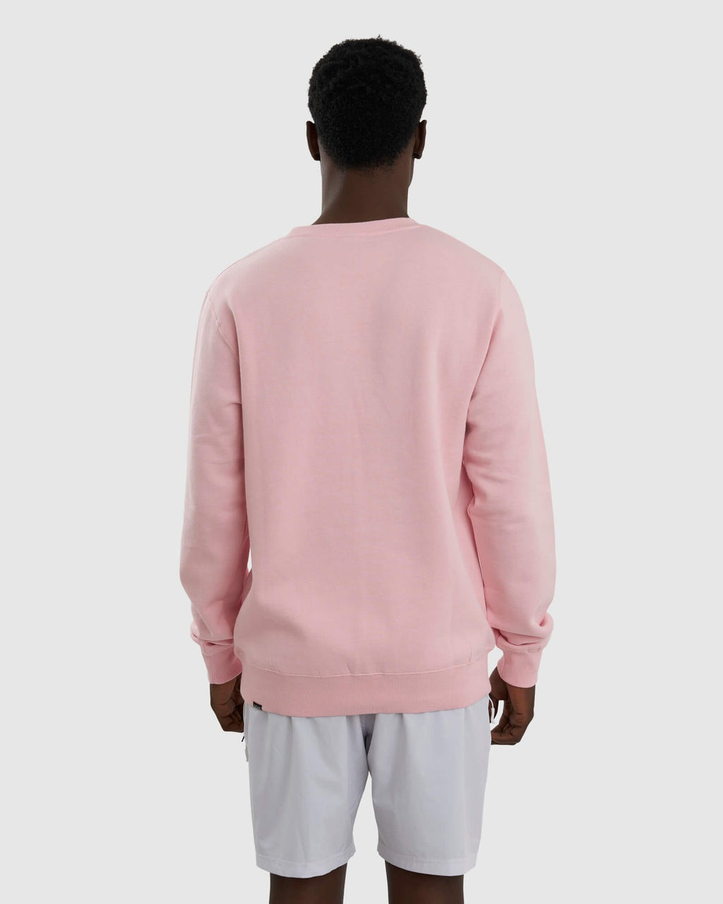 Model wearing Unisex Imprint Sweater - Petal Pink