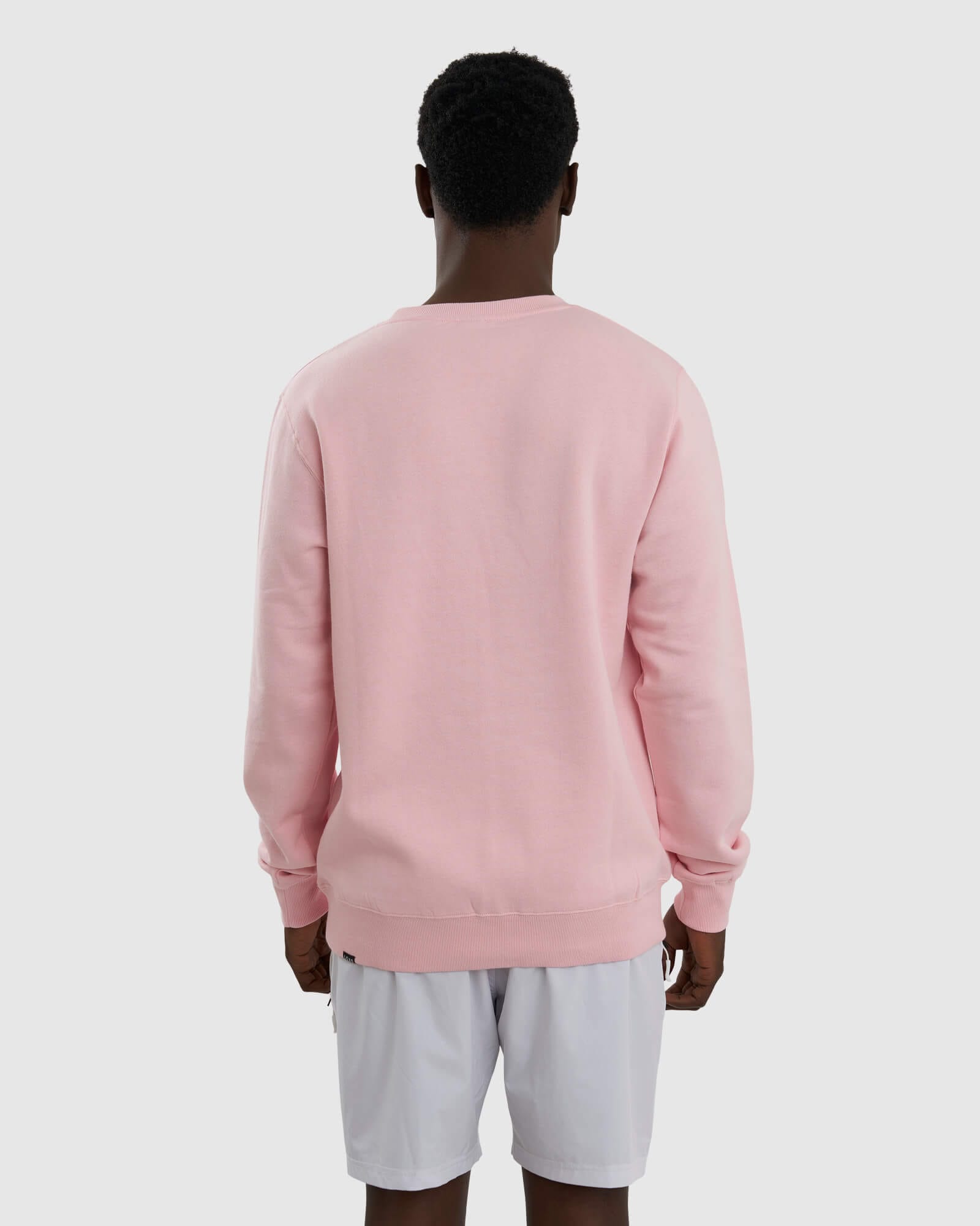 Model wearing Unisex Imprint Sweater - Petal Pink
