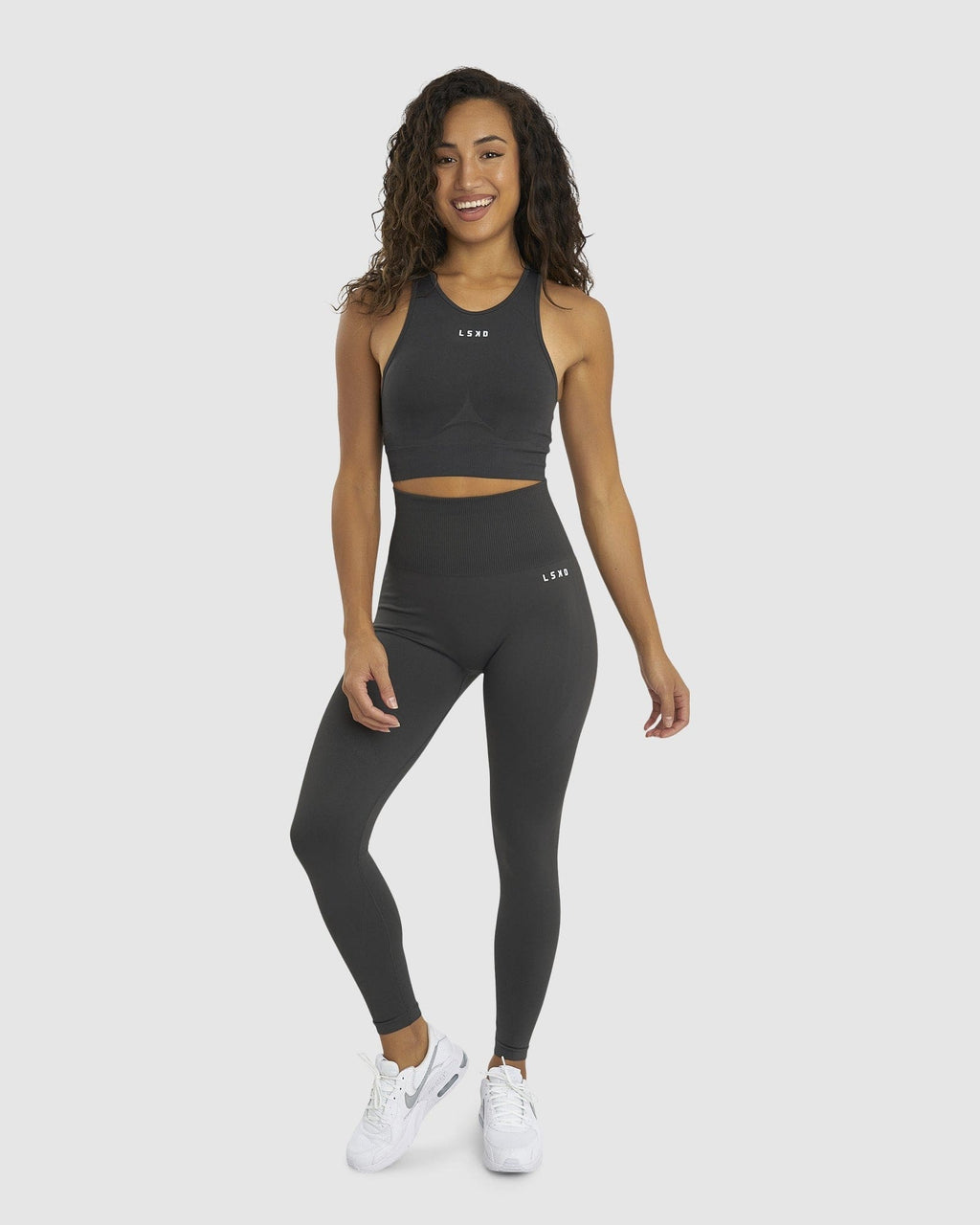Model wearing Limitless Seamless 7/8 Length Tights - Charcoal