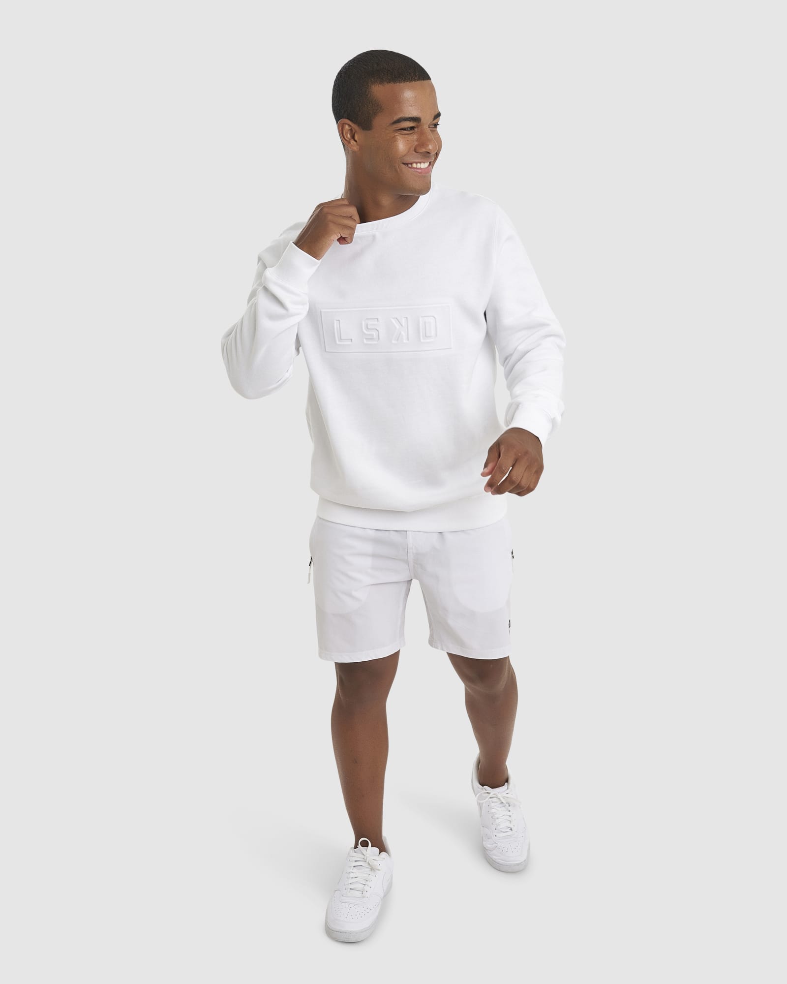 Model wearing Unisex Imprint Sweater - White