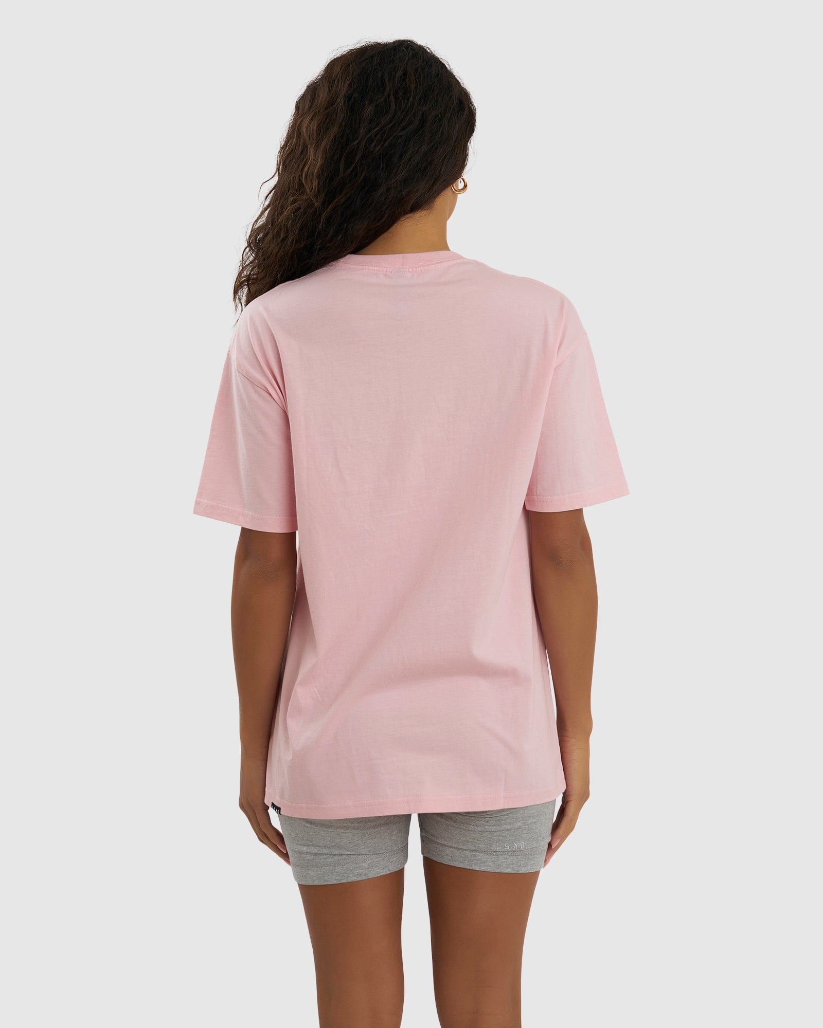 Model wearing Unisex Imprint Tee Oversize - Petal Pink