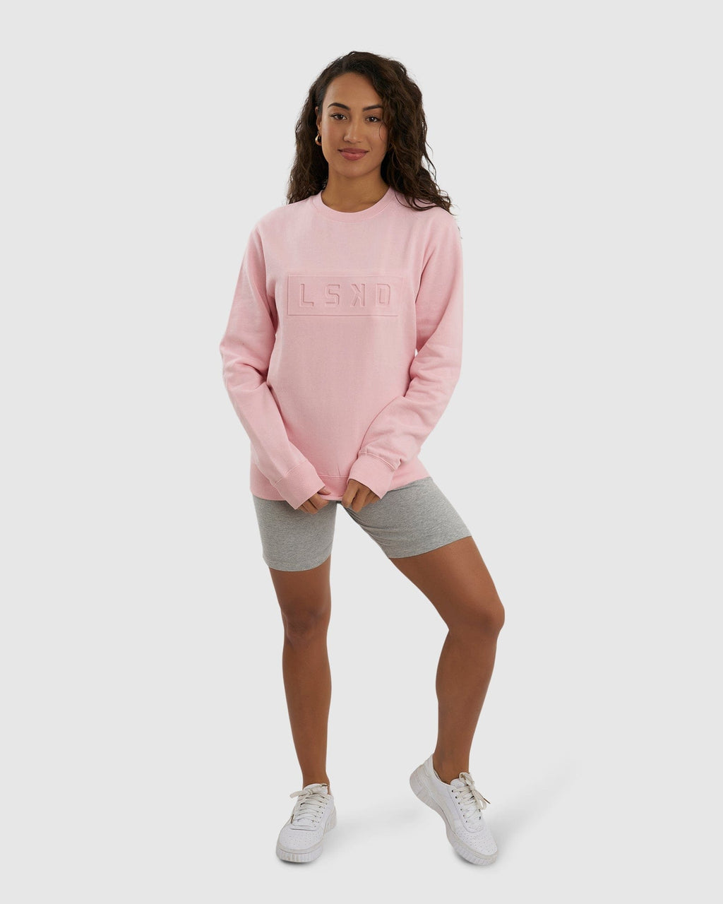 Model wearing Unisex Imprint Sweater - Petal Pink