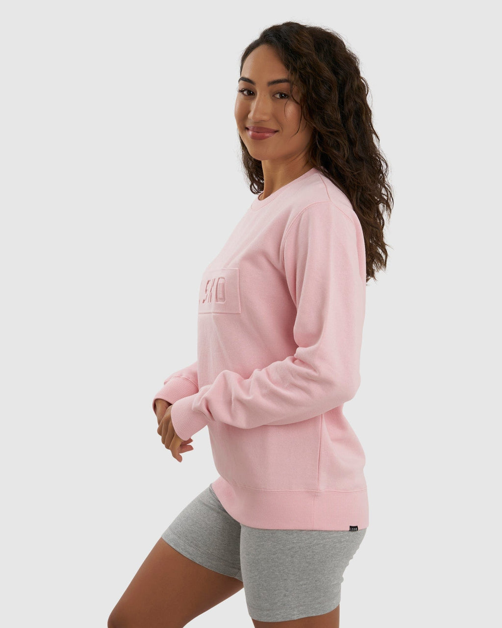 Model wearing Unisex Imprint Sweater - Petal Pink