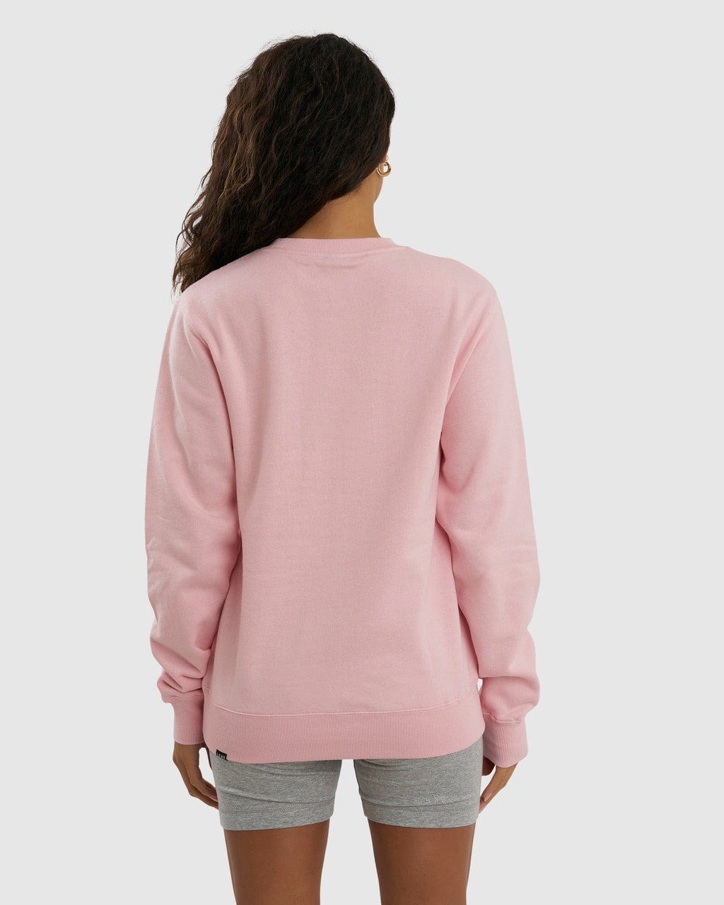 Model wearing Unisex Imprint Sweater - Petal Pink