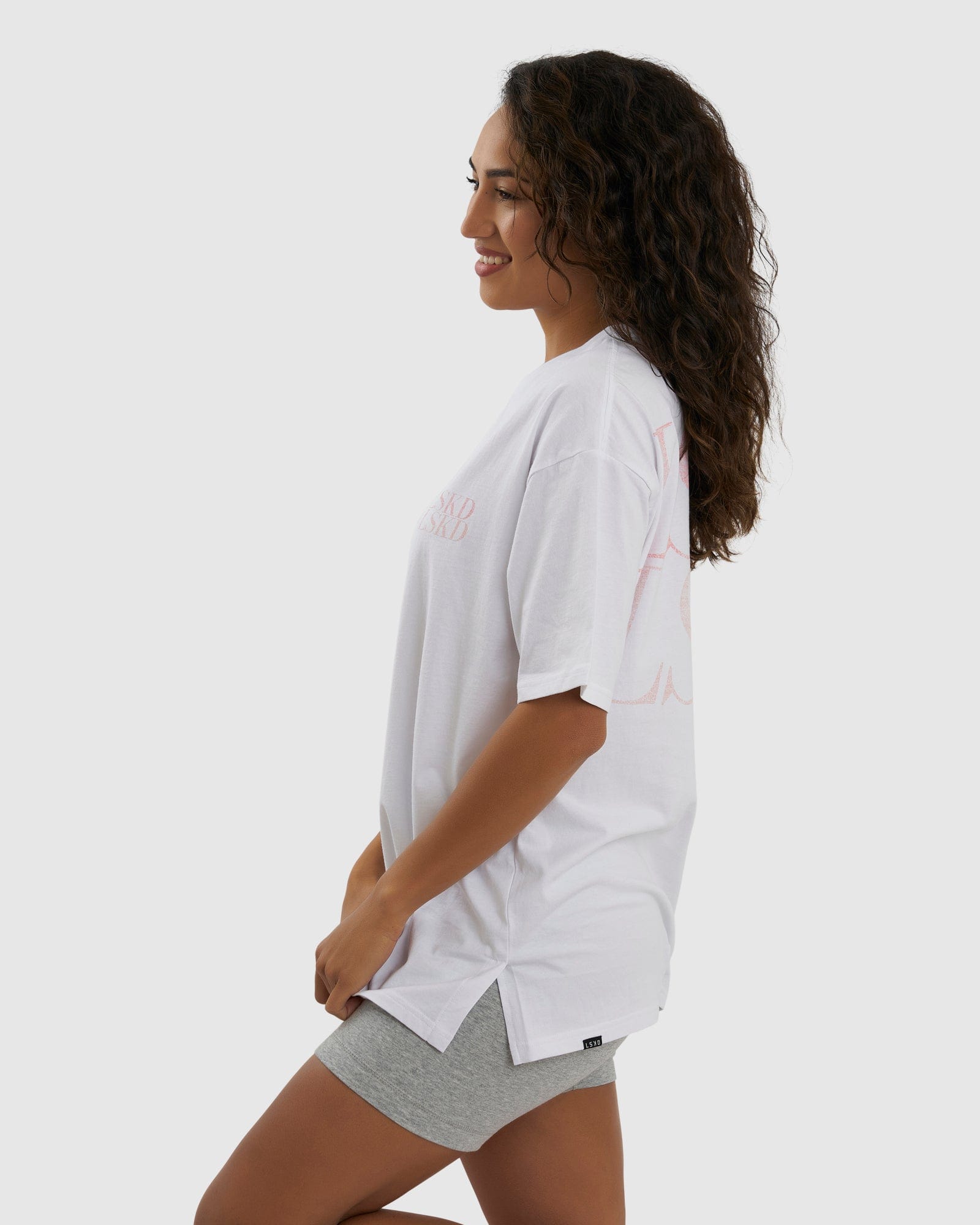 Model wearing Unisex Aurora Tee Oversized - White