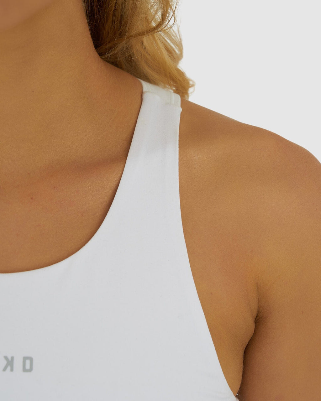 Model wearing Base Crop Tank - White