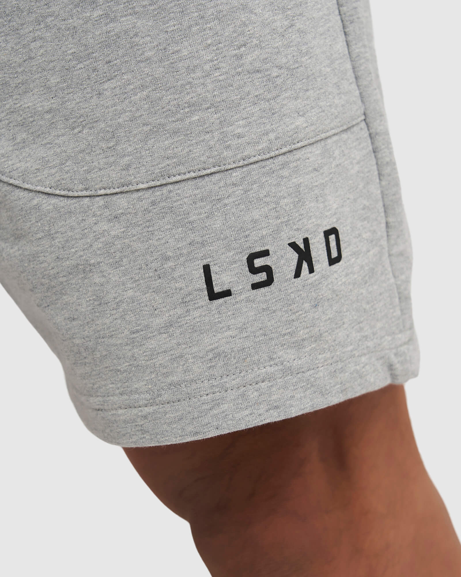 Model wearing Routine Track Short - Light Grey Marl