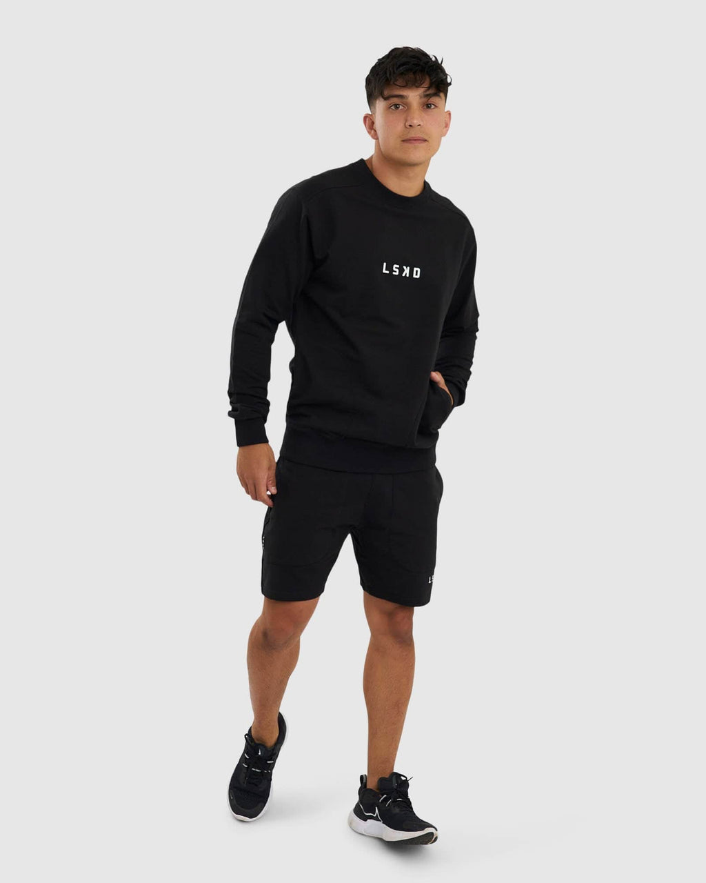 Model wearing Routine Track Short - Black