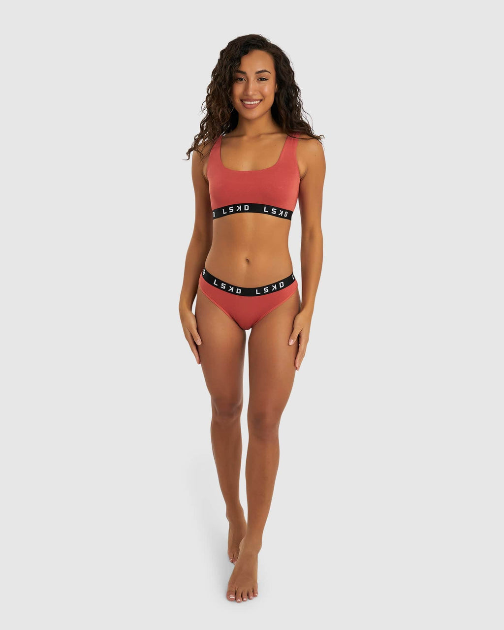 Model wearing Gigi Bikini Brief - Hot Tamale