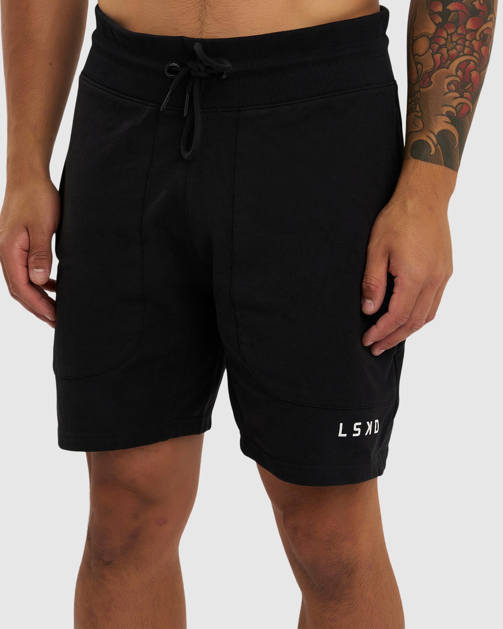 Model wearing Routine Track Short - Black