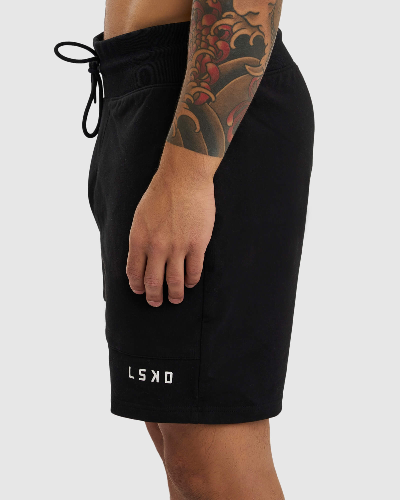 Model wearing Routine Track Short - Black