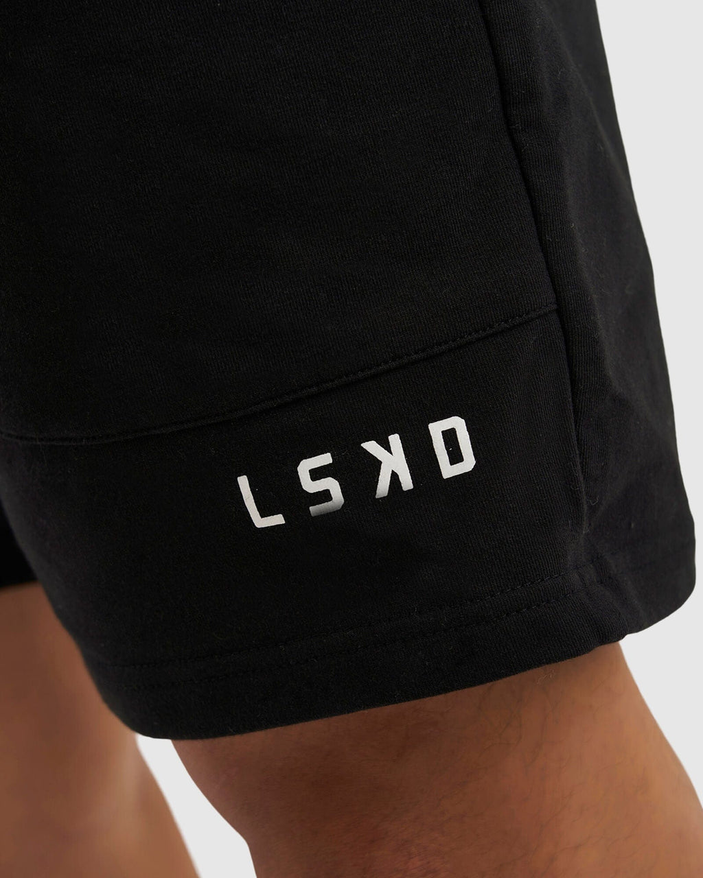 Model wearing Routine Track Short - Black