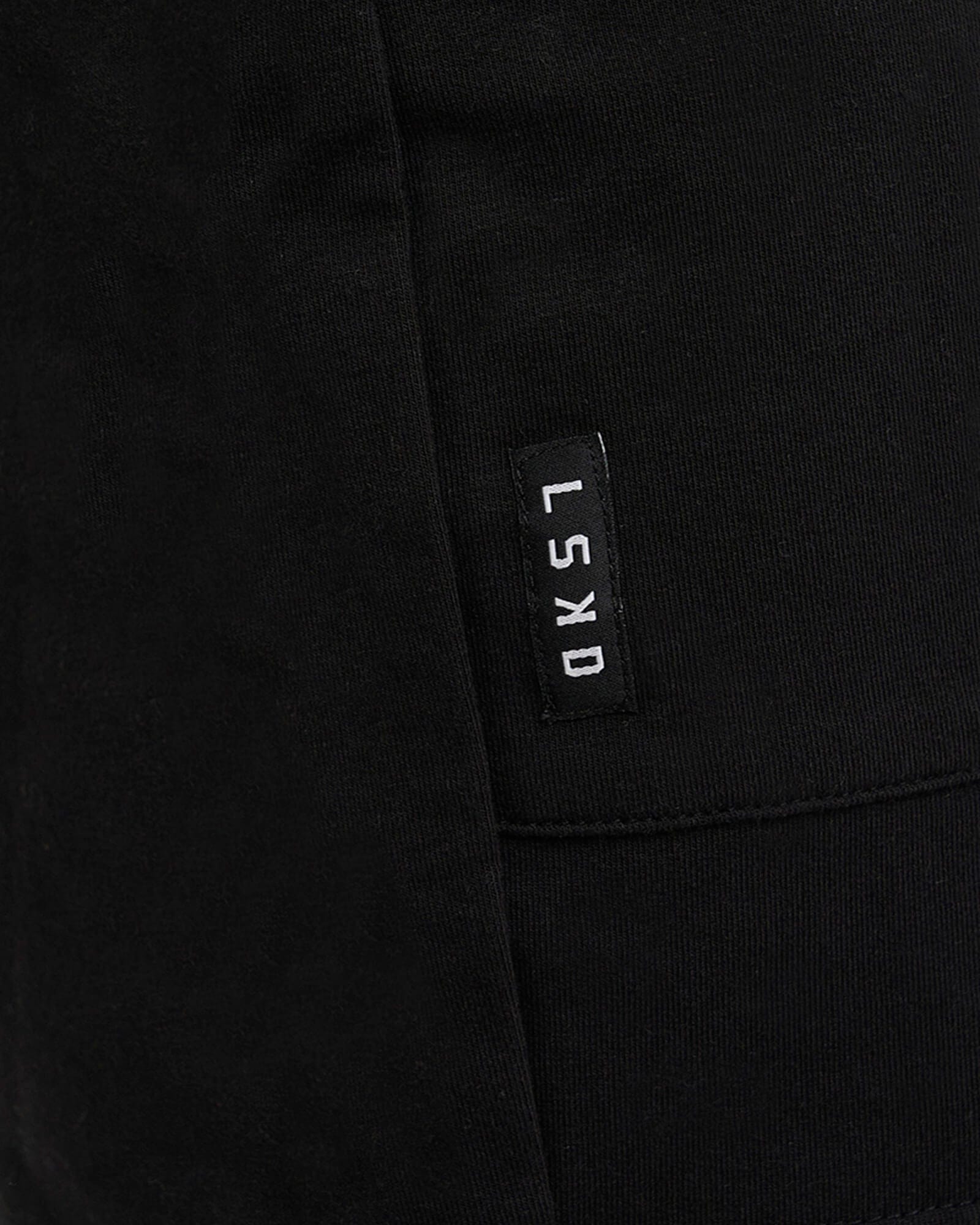 Model wearing Routine Track Short - Black