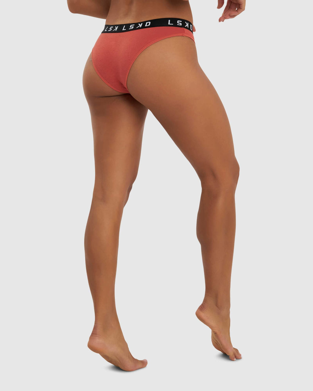 Model wearing Gigi Bikini Brief - Hot Tamale