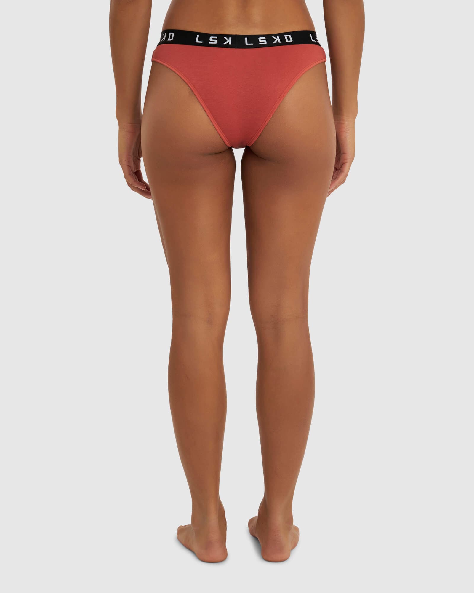 Model wearing Gigi Bikini Brief - Hot Tamale