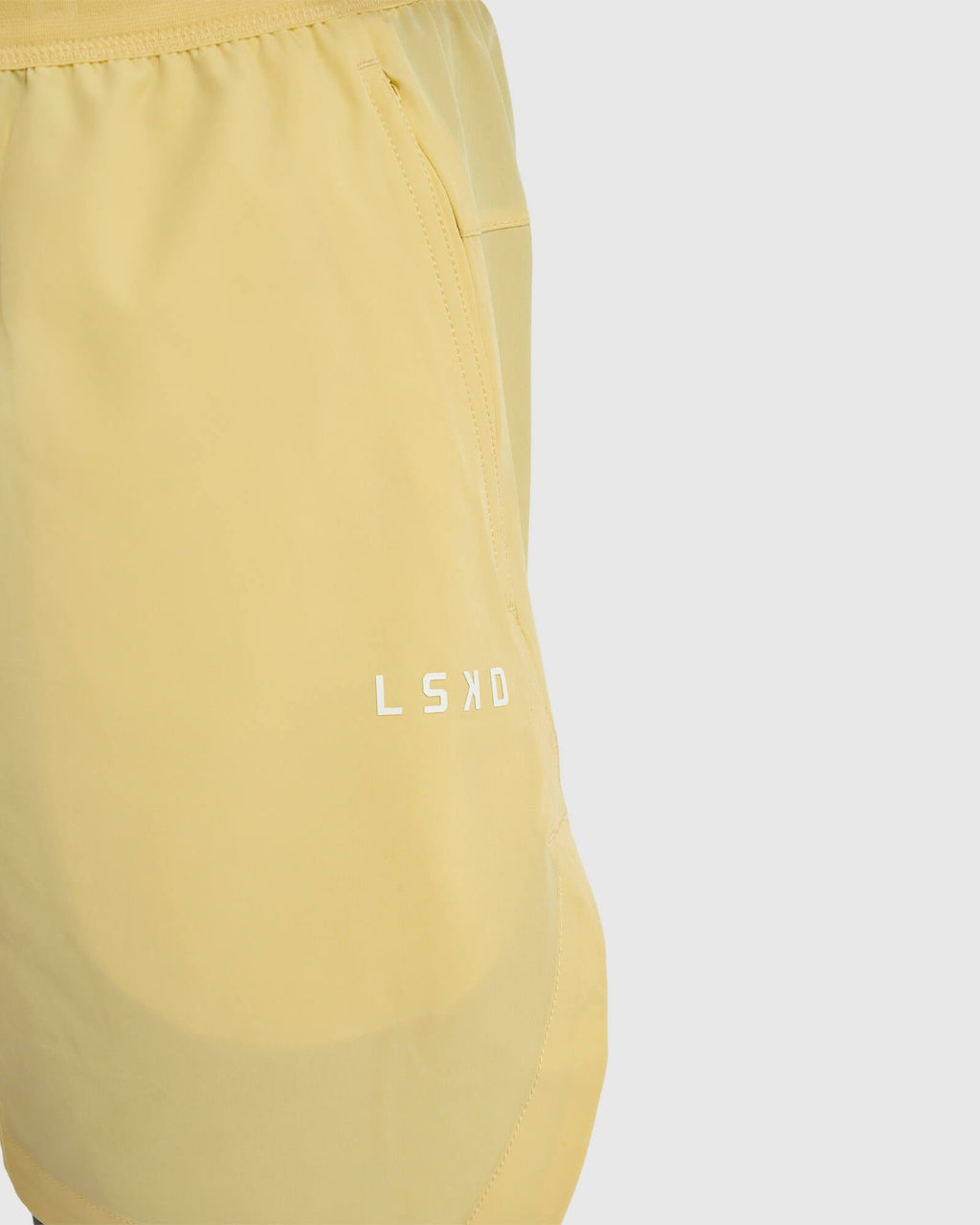 Model wearing Competition 8" Performance Short - Banana Smoothie