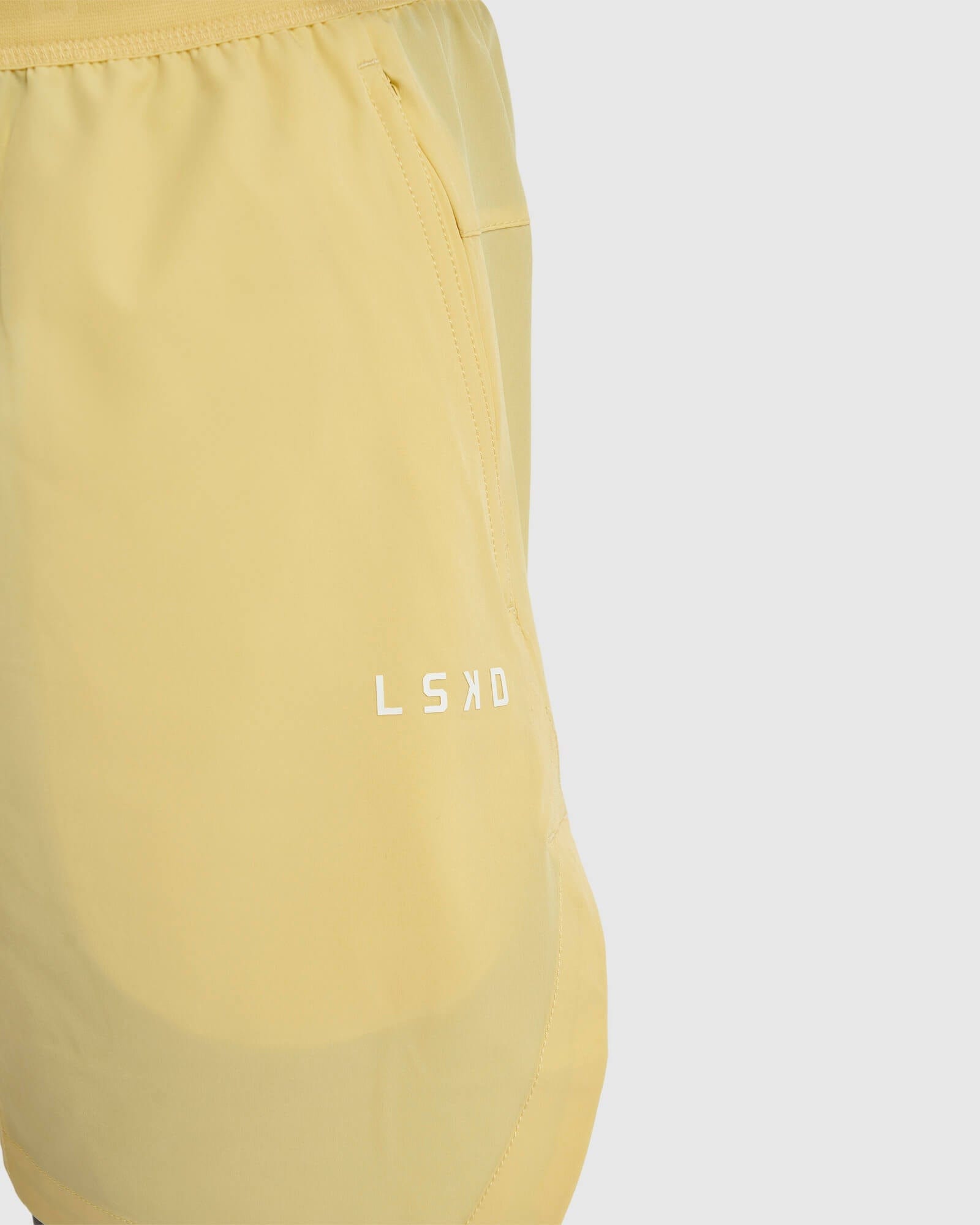 Model wearing Competition 8" Performance Short - Banana Smoothie