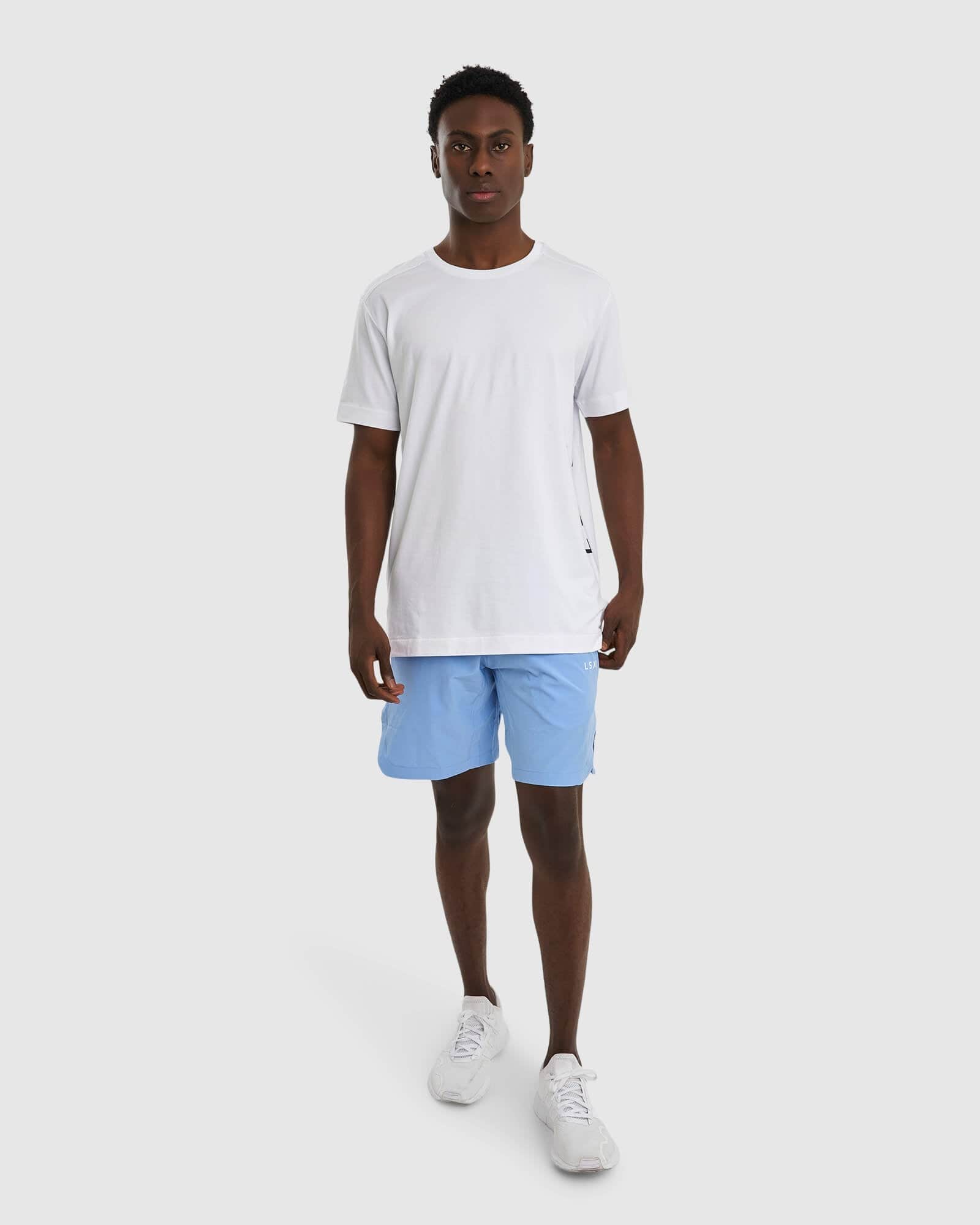 Model wearing Competition 8" Performance Short - Soft Blue