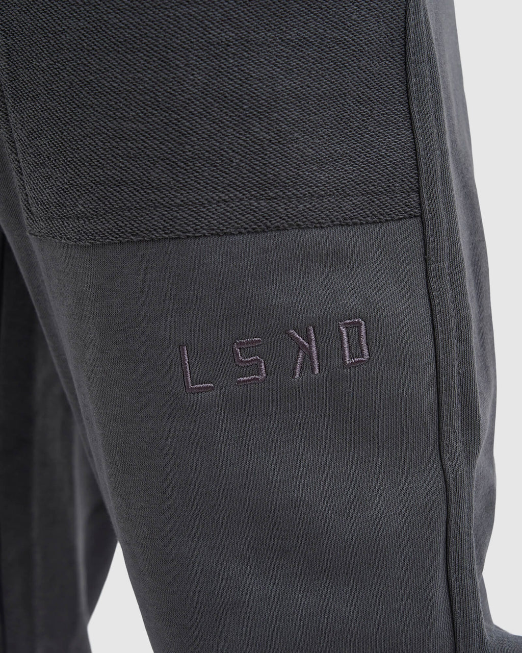 Model wearing Unisex Locker Room Track Pant - Iron