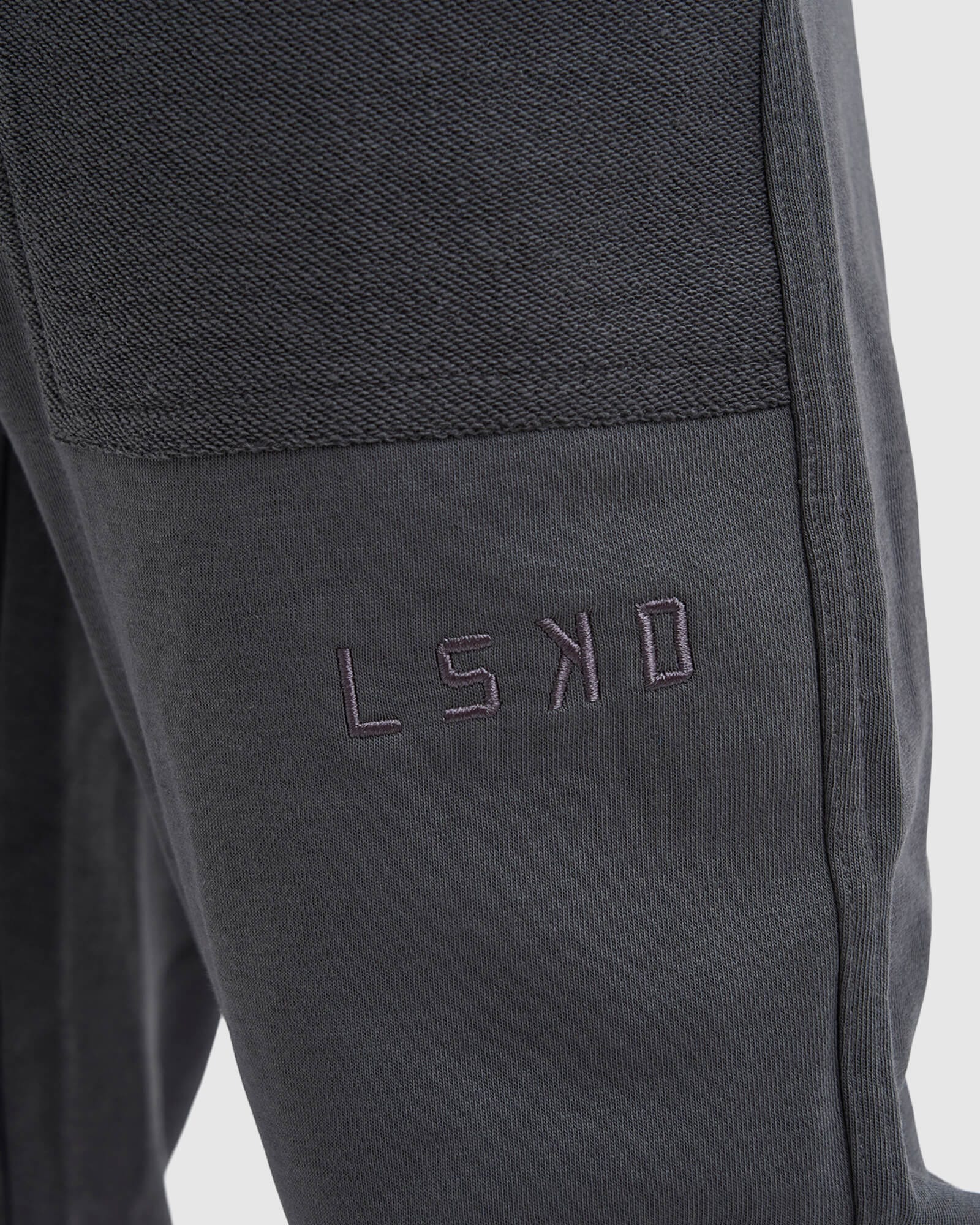 Model wearing Unisex Locker Room Track Pant - Iron