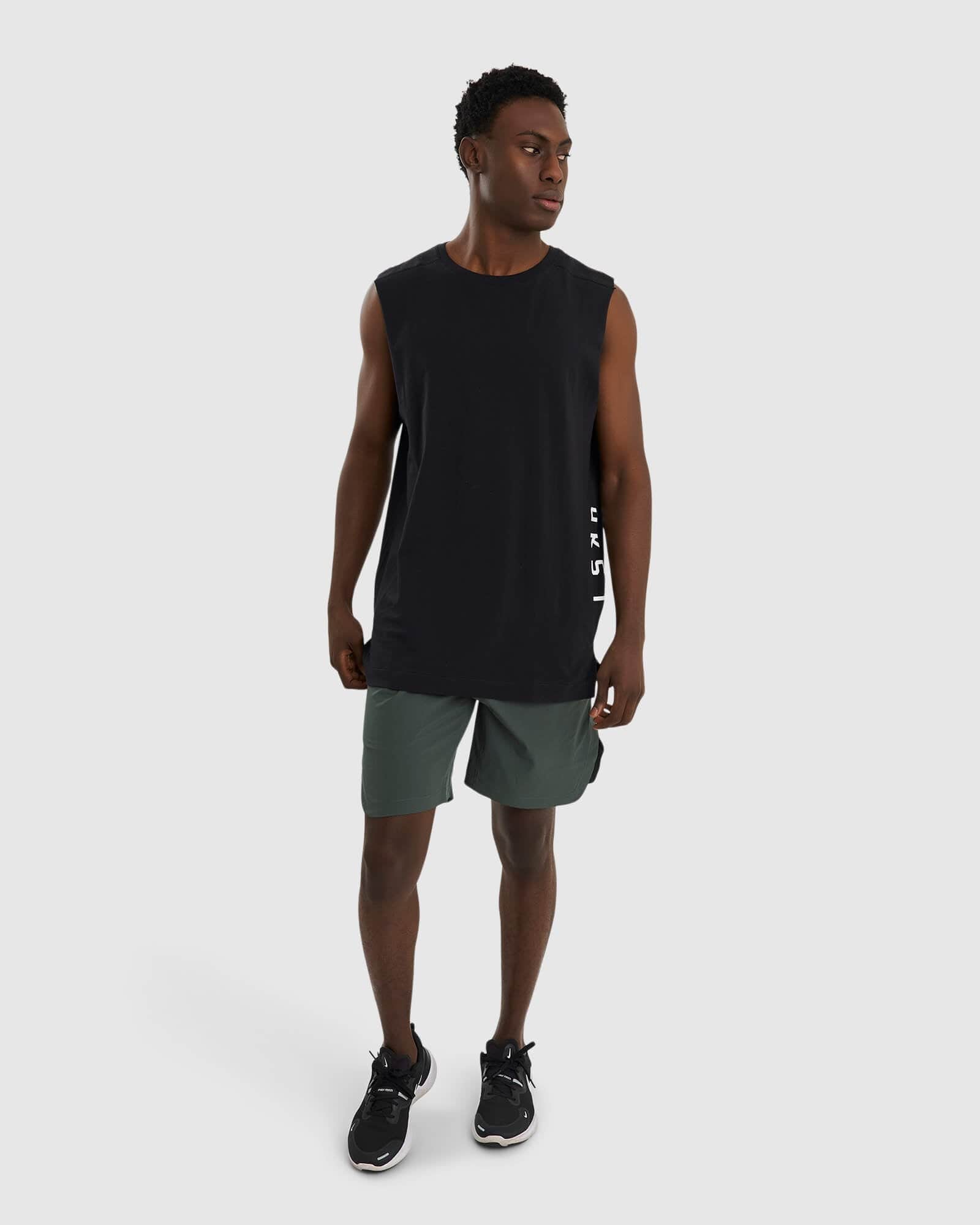 Model wearing Competition 8" Performance Short - Carbon Green
