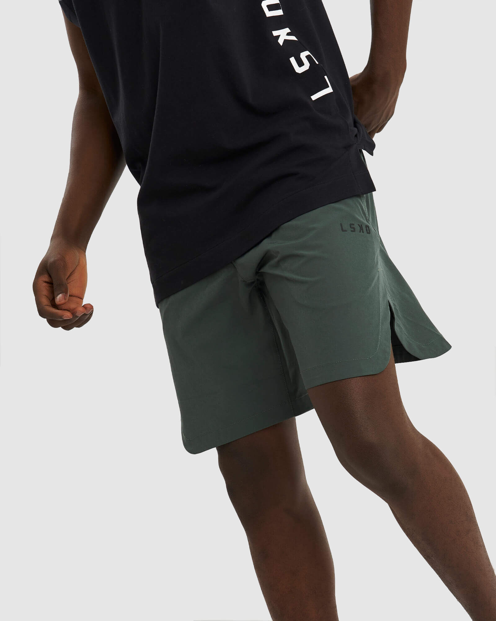 Model wearing Competition 8" Performance Short - Carbon Green