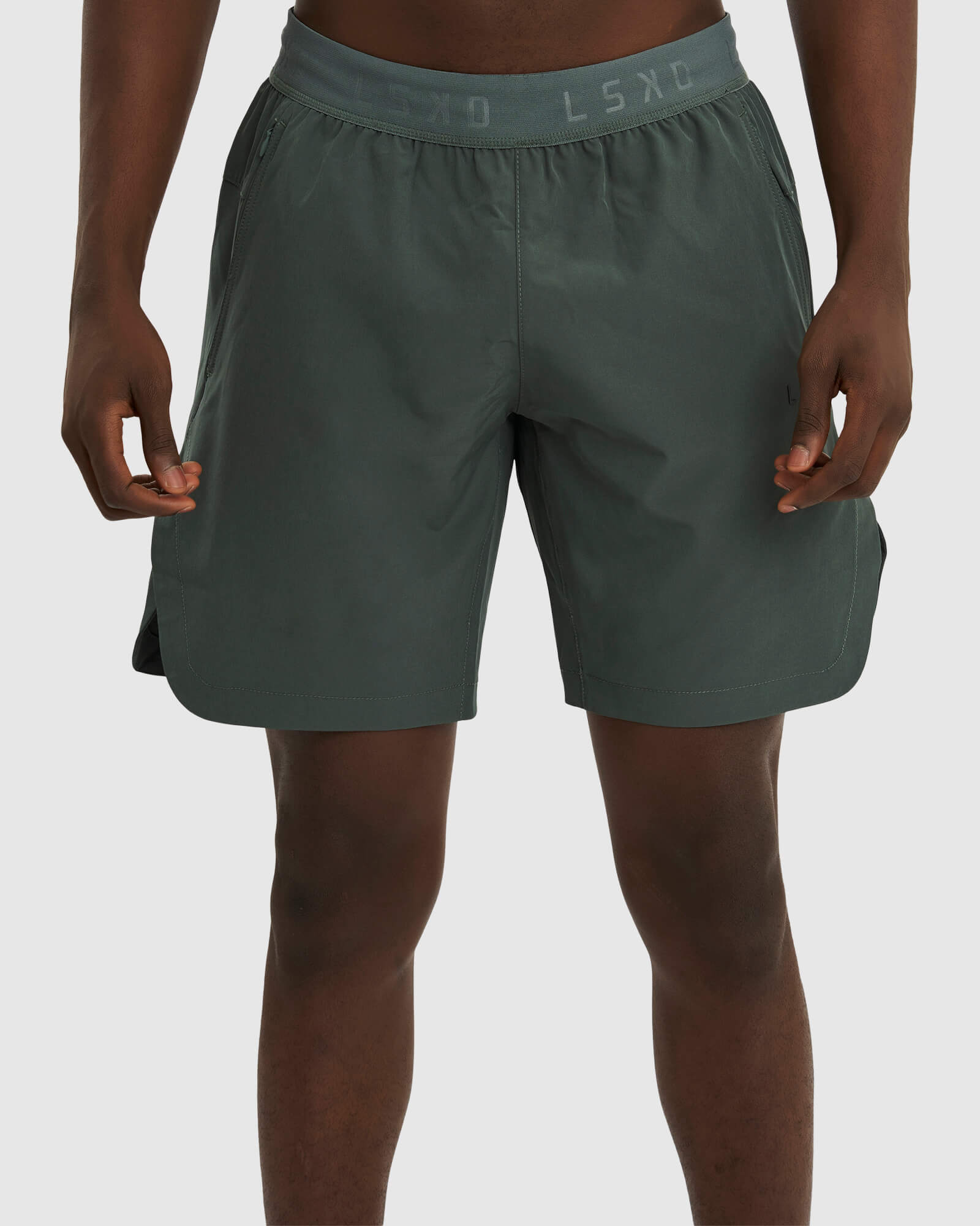 Model wearing Competition 8" Performance Short - Carbon Green
