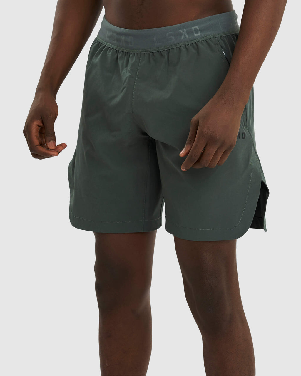 Model wearing Competition 8" Performance Short - Carbon Green