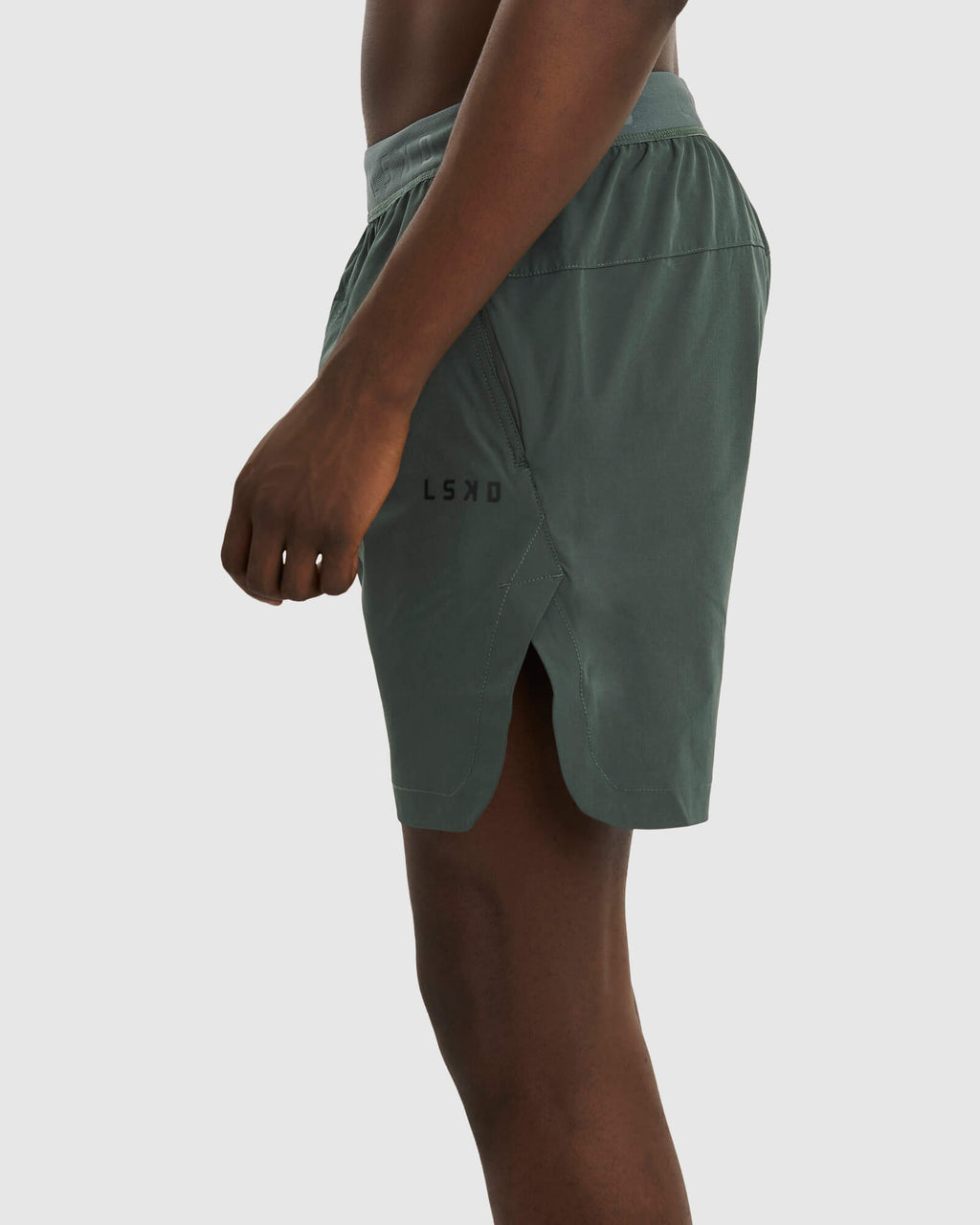 Model wearing Competition 8" Performance Short - Carbon Green