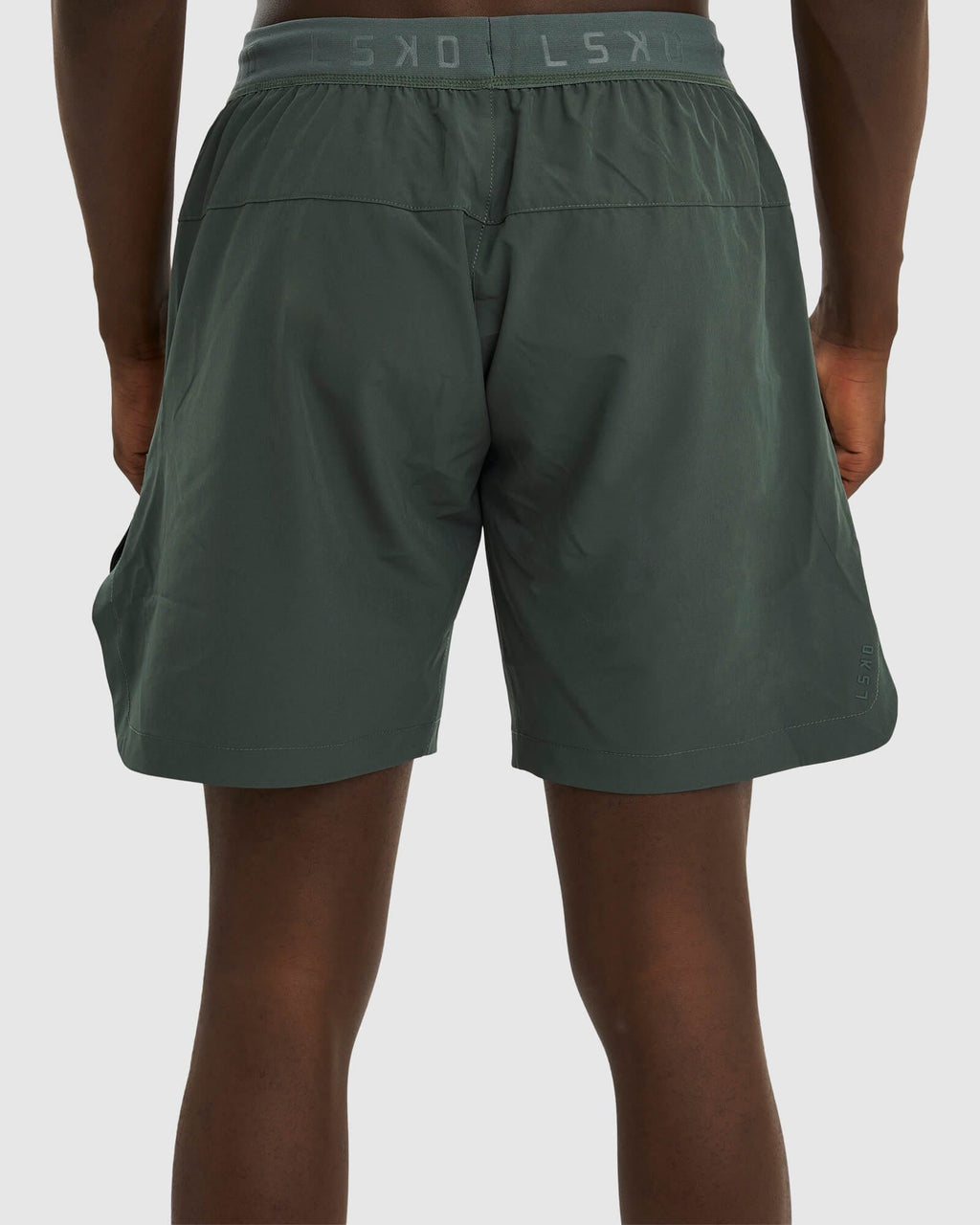Model wearing Competition 8" Performance Short - Carbon Green