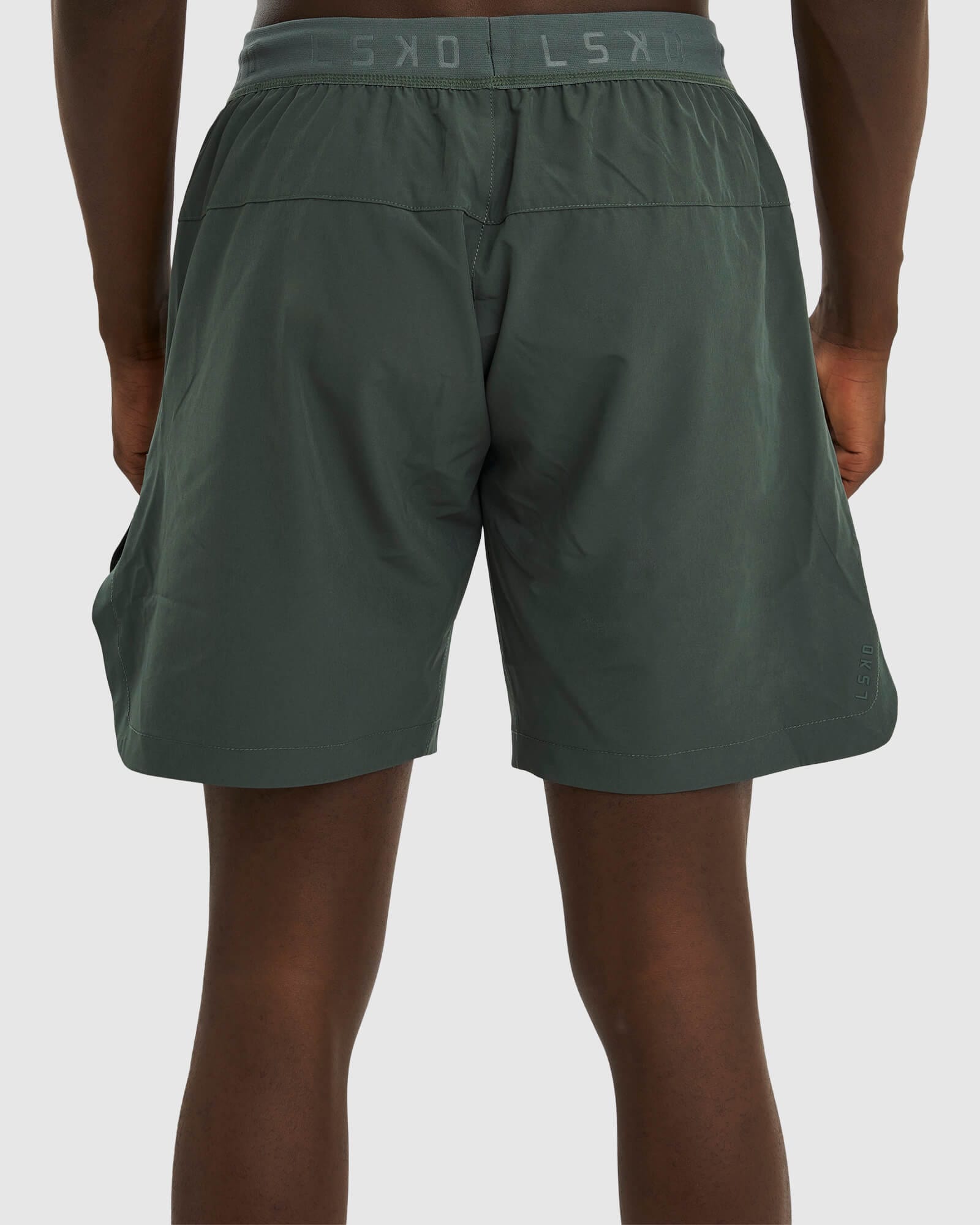 Model wearing Competition 8" Performance Short - Carbon Green