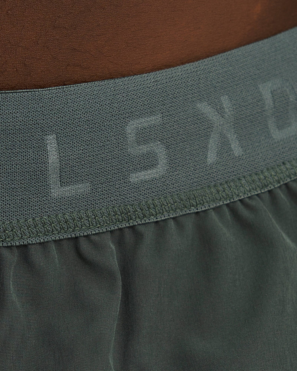 Model wearing Competition 8" Performance Short - Carbon Green