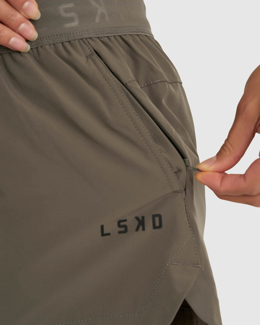 Model wearing Competition Performance Short - Walnut Grey