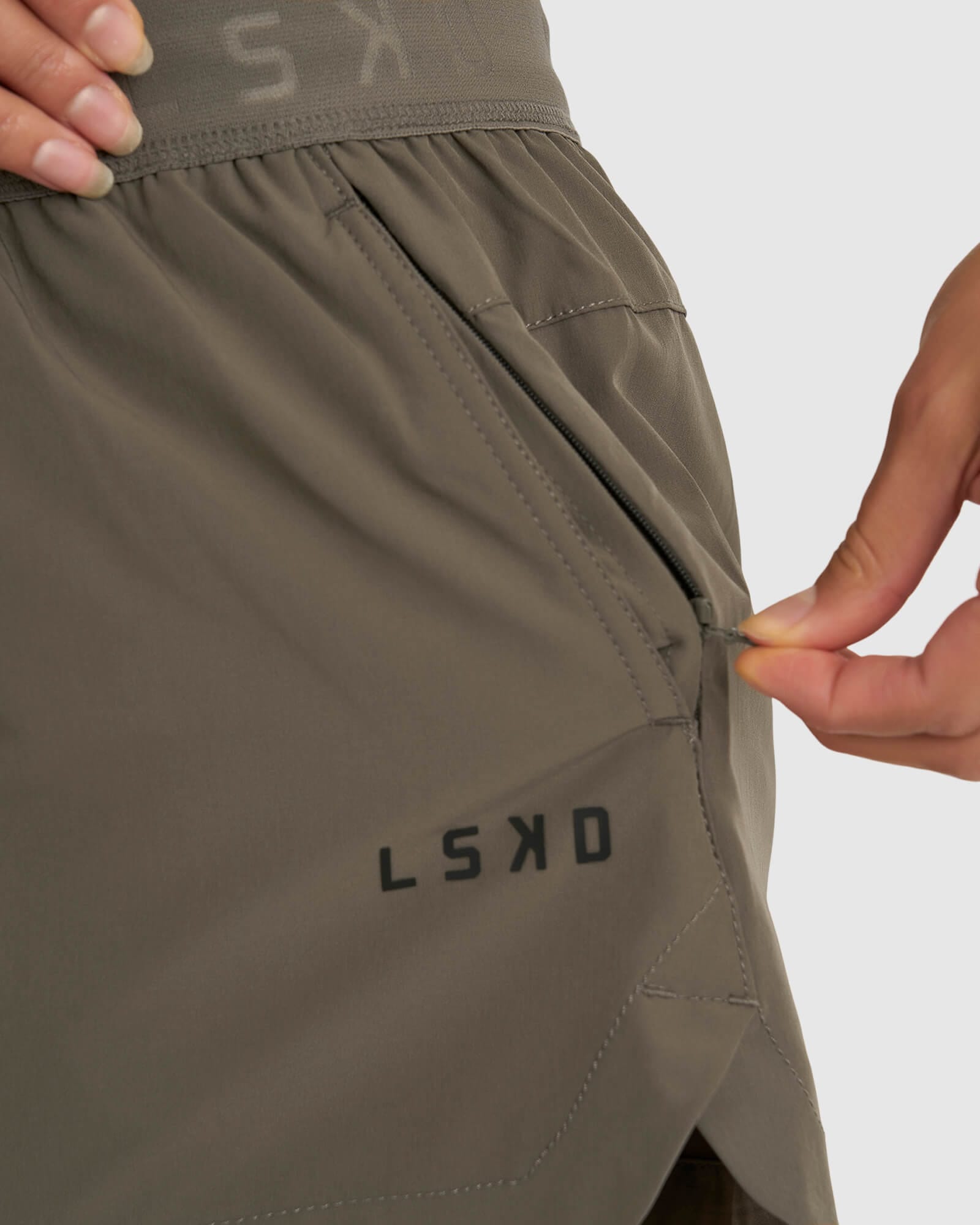 Model wearing Competition Performance Short - Walnut Grey