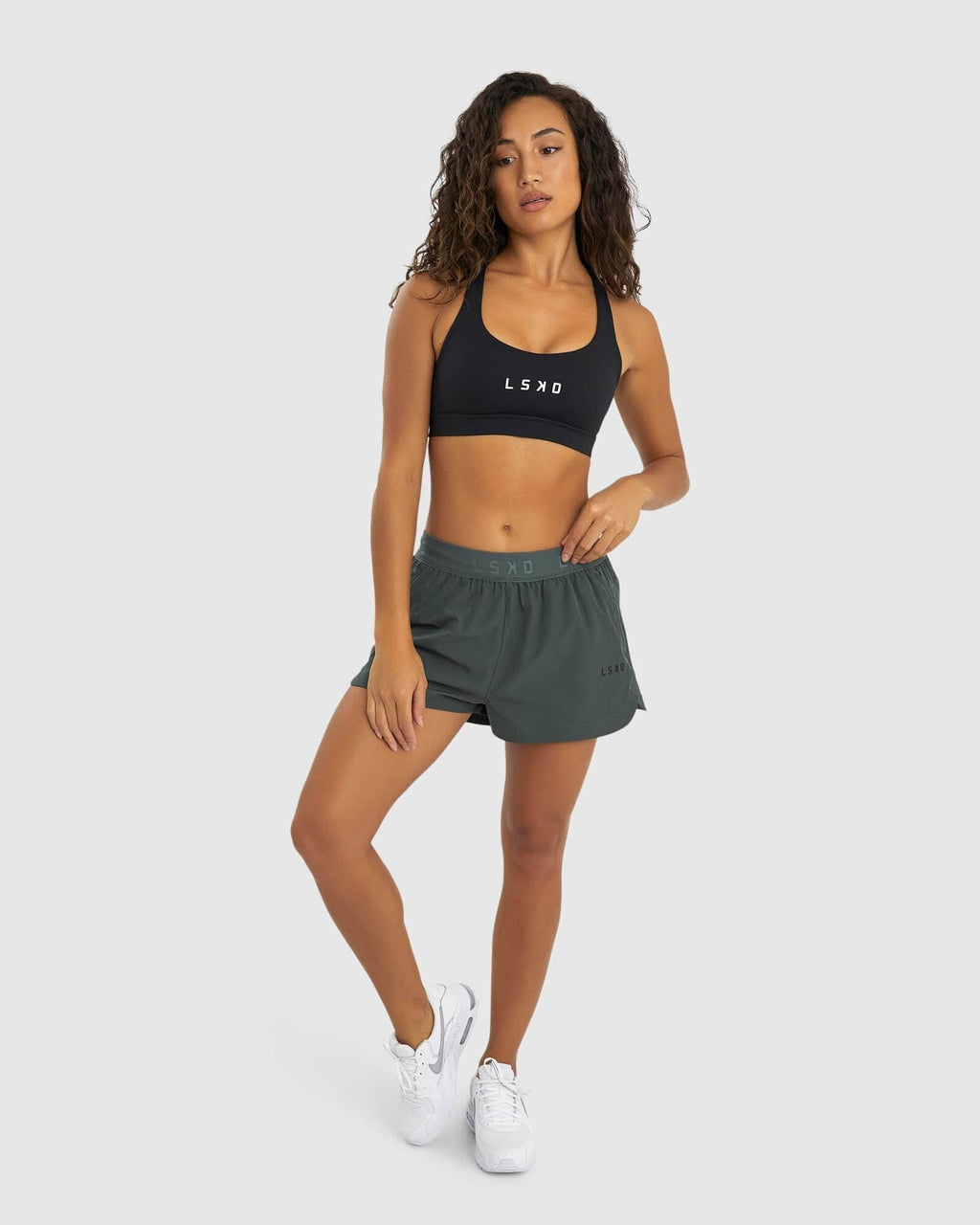 Model wearing Competition Performance Short - Carbon Green