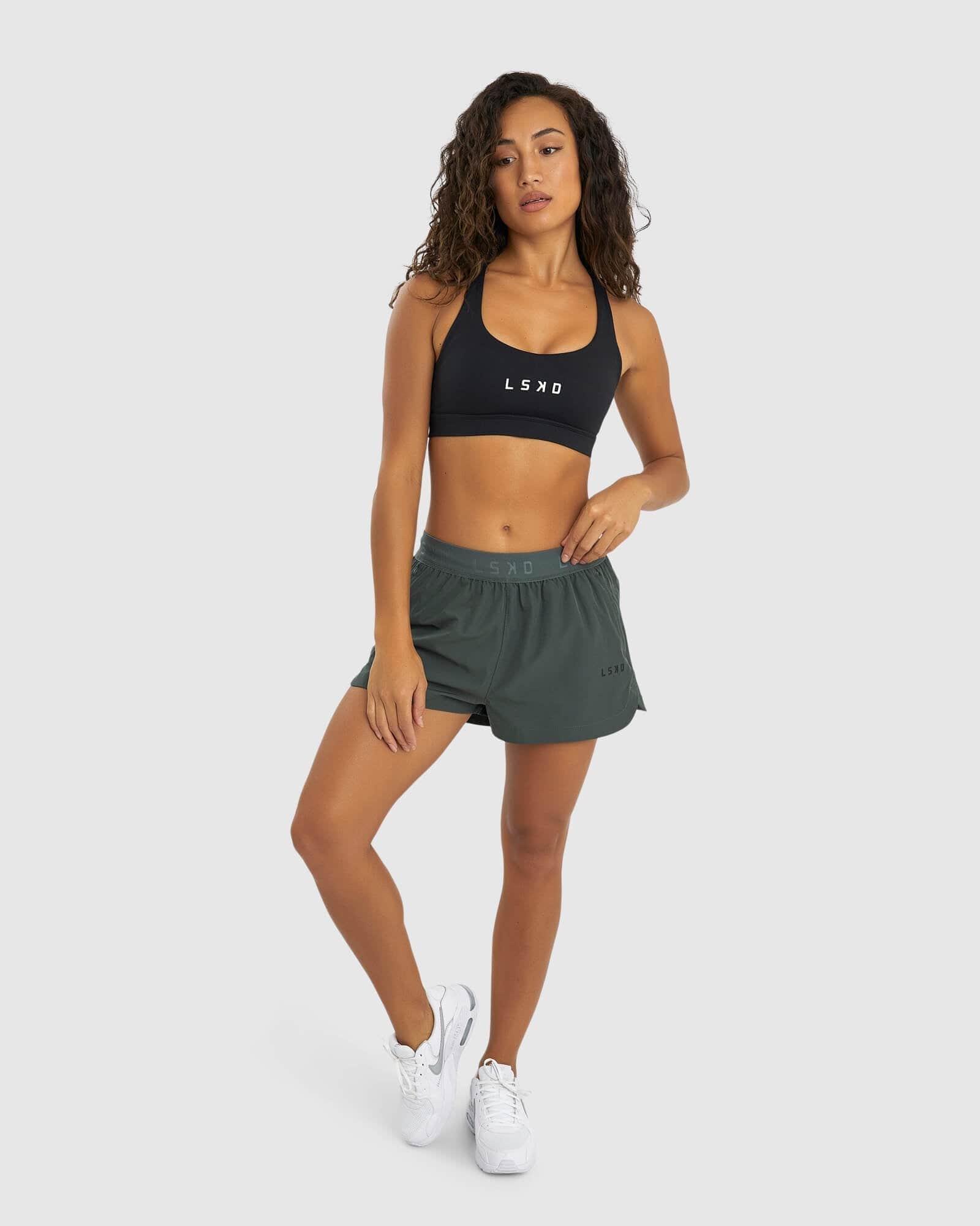 Model wearing Competition Performance Short - Carbon Green