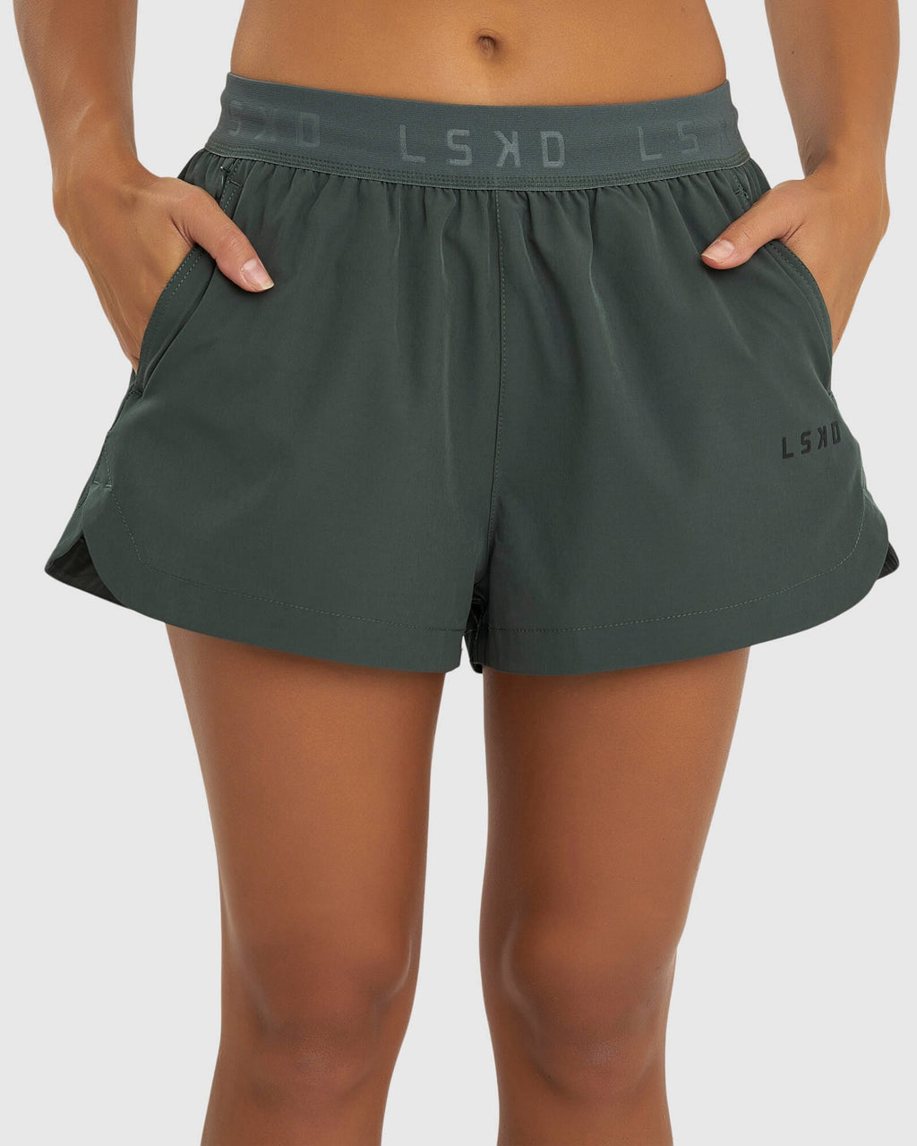 Model wearing Competition Performance Short - Carbon Green