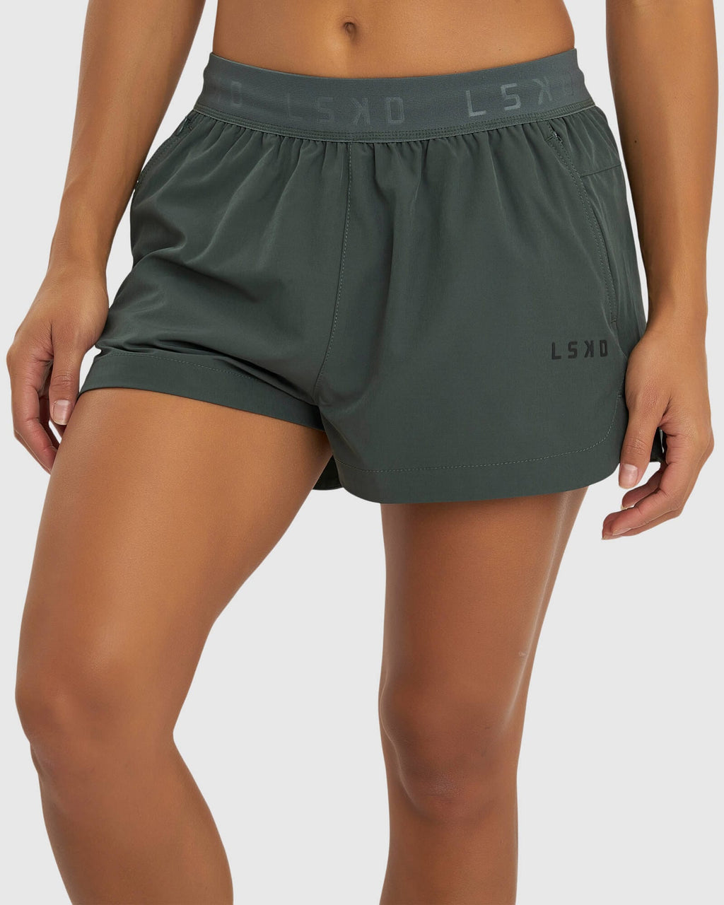 Model wearing Competition Performance Short - Carbon Green