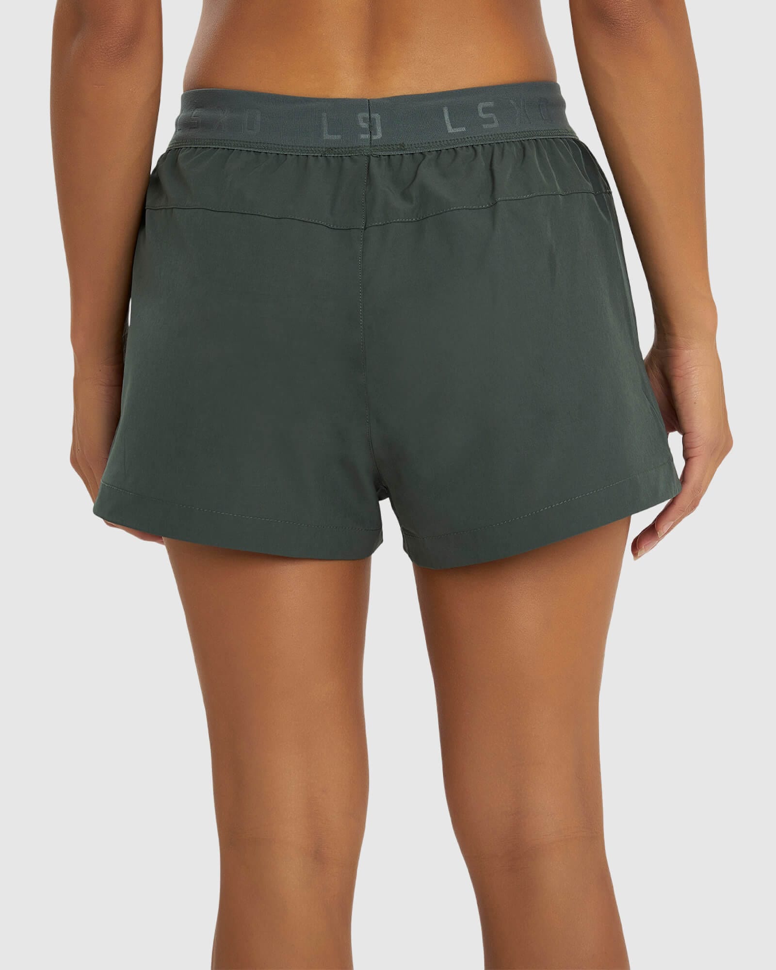 Model wearing Competition Performance Short - Carbon Green