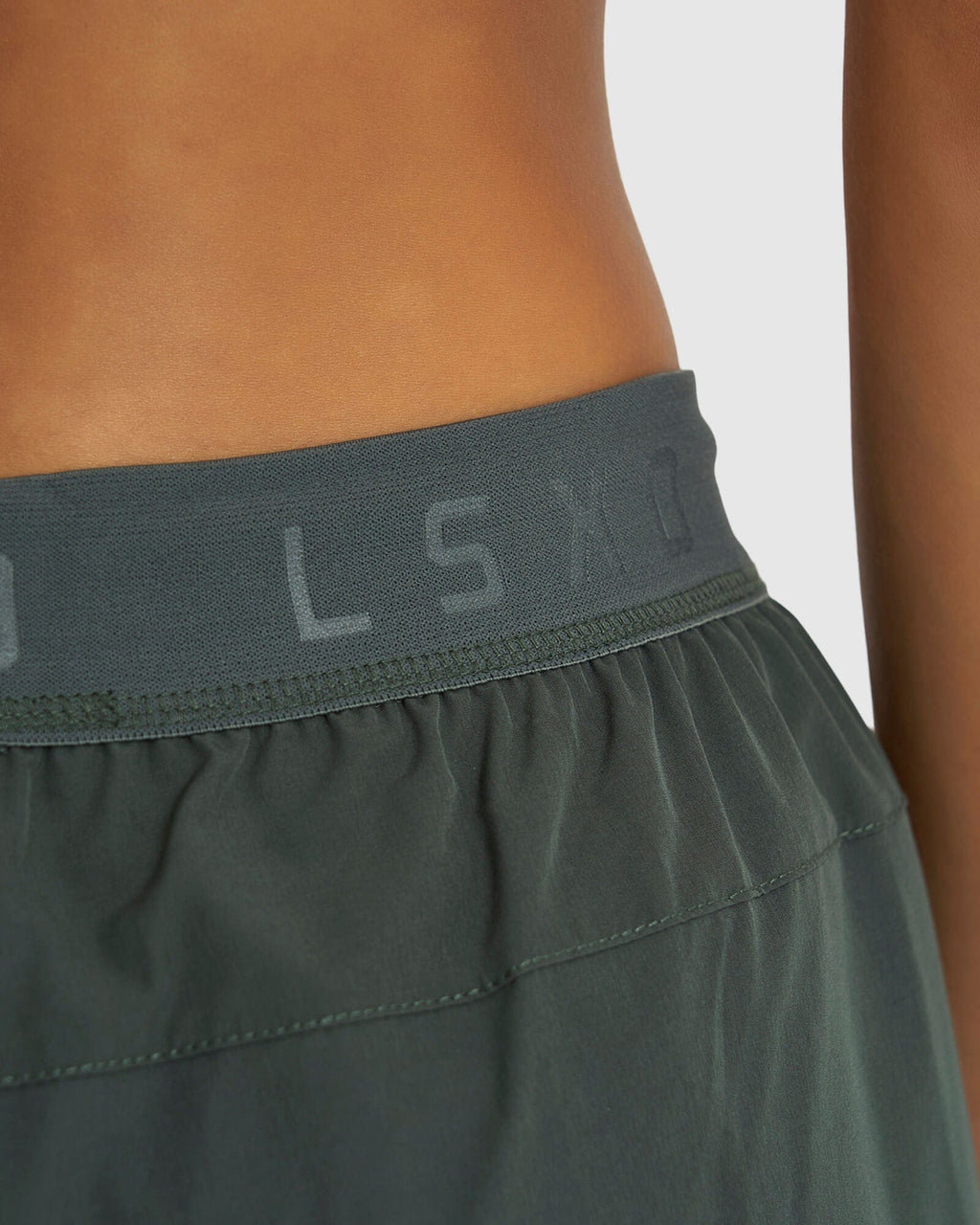 Model wearing Competition Performance Short - Carbon Green