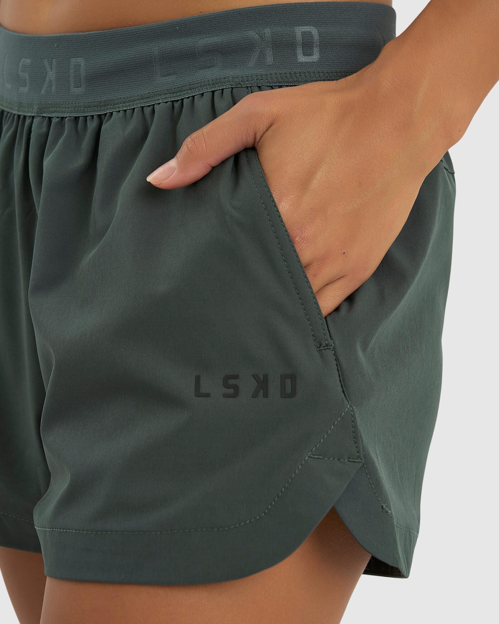 Model wearing Competition Performance Short - Carbon Green